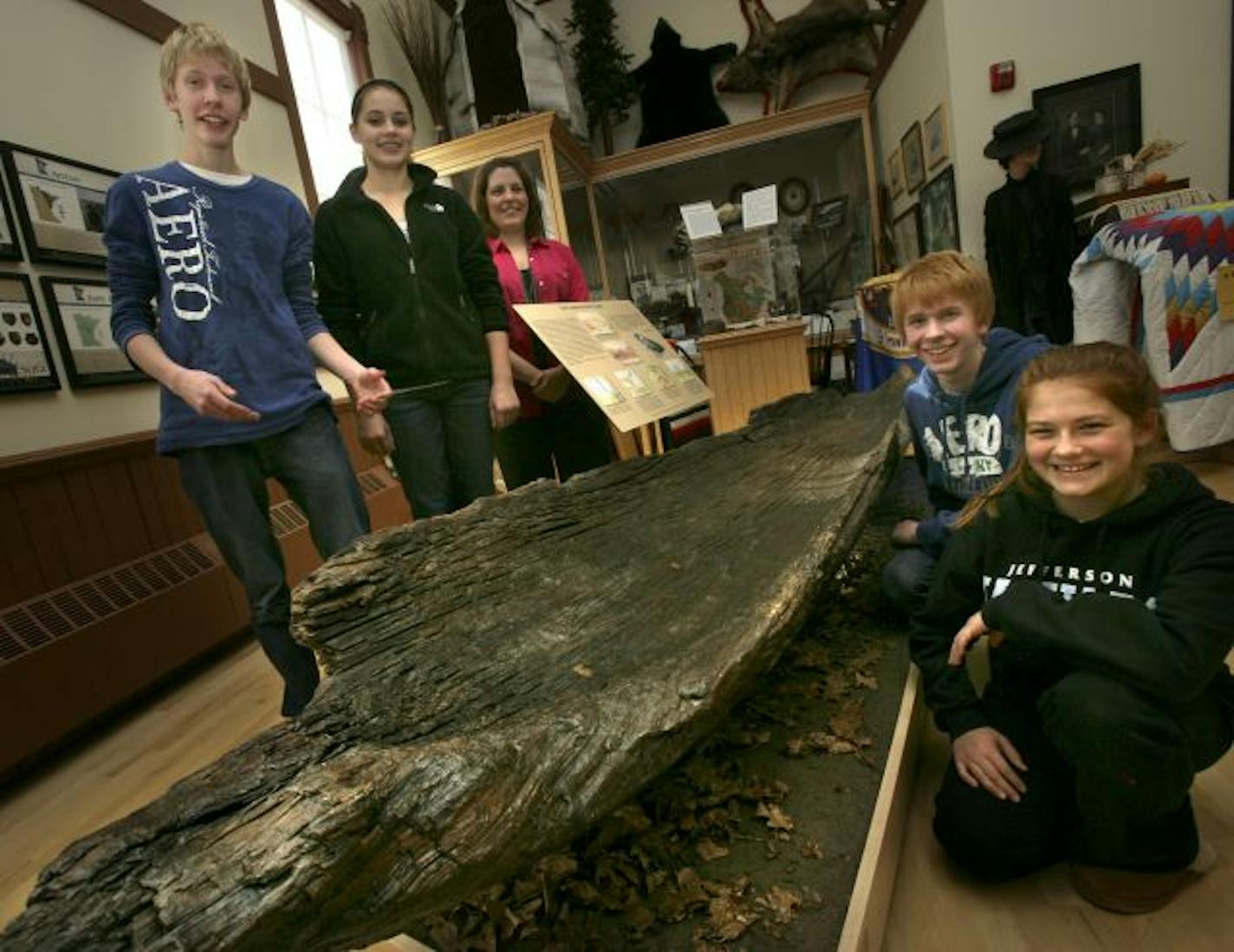 Students in Laurie Dahlgren's eighth-grade social studies class at Olson Middle School sold candy and held other fundraisers to help preserve a 400-year-old canoe unearthed in 1967. From left are Tanner Myhre, Maddie Peterson, Dahlgren, Connor Myhre and Katie Peroutka.