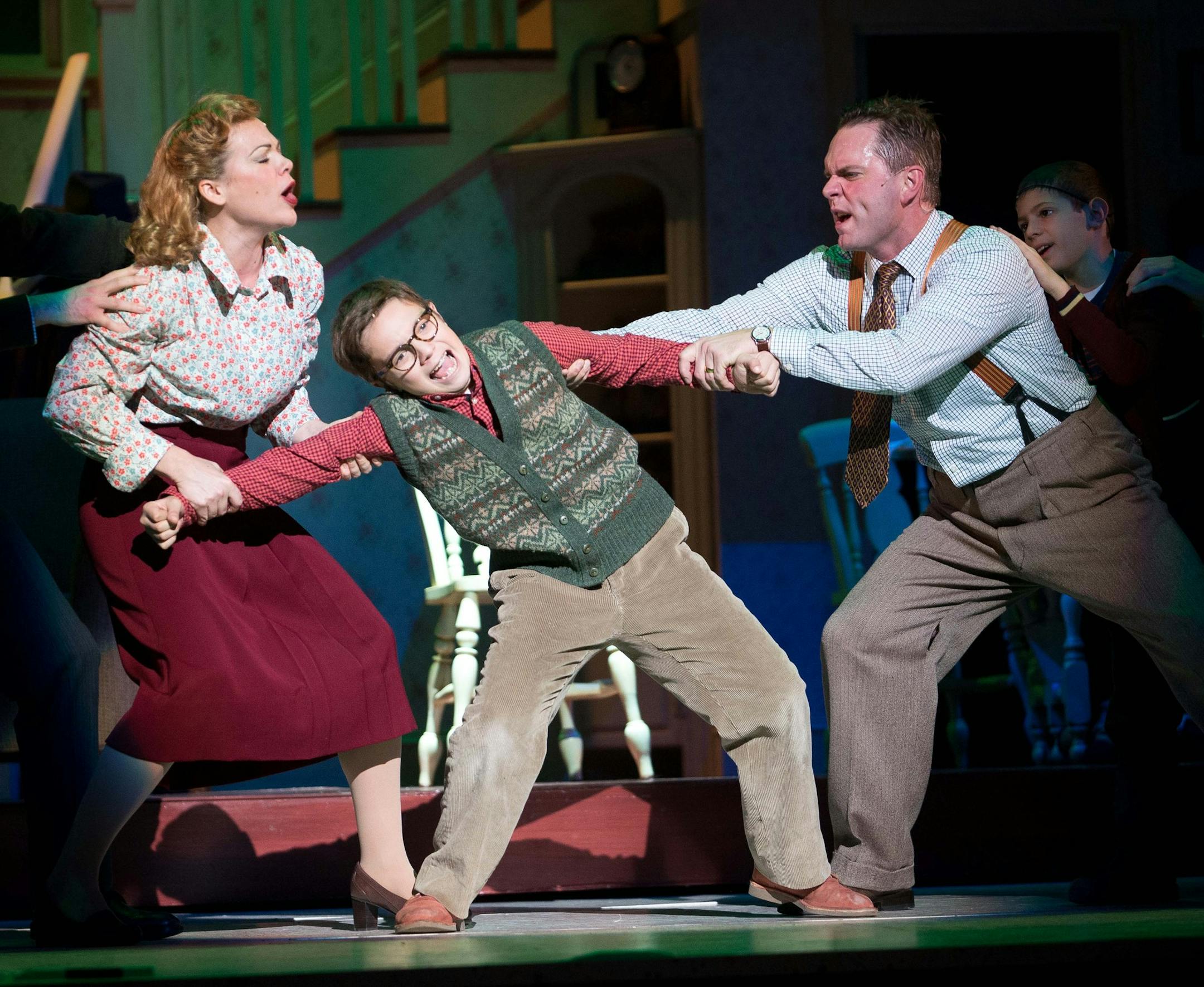 Ralphie, played by Jake Goodman, is pulled between his parents, played by Billie Wildrick, left and Dieter Bierbrauer in a dress rehearsal of the Ordway Production of "A Christmas Story: The Musical" on Saturday. ] AARON LAVINSKY • aaron.lavinsky@startribune.com Dress rehearsal of the Ordway Production of "A Christmas Story: The Musical" on Saturday, Nov. 29, 2014 at Ordway Theater in St. Paul.