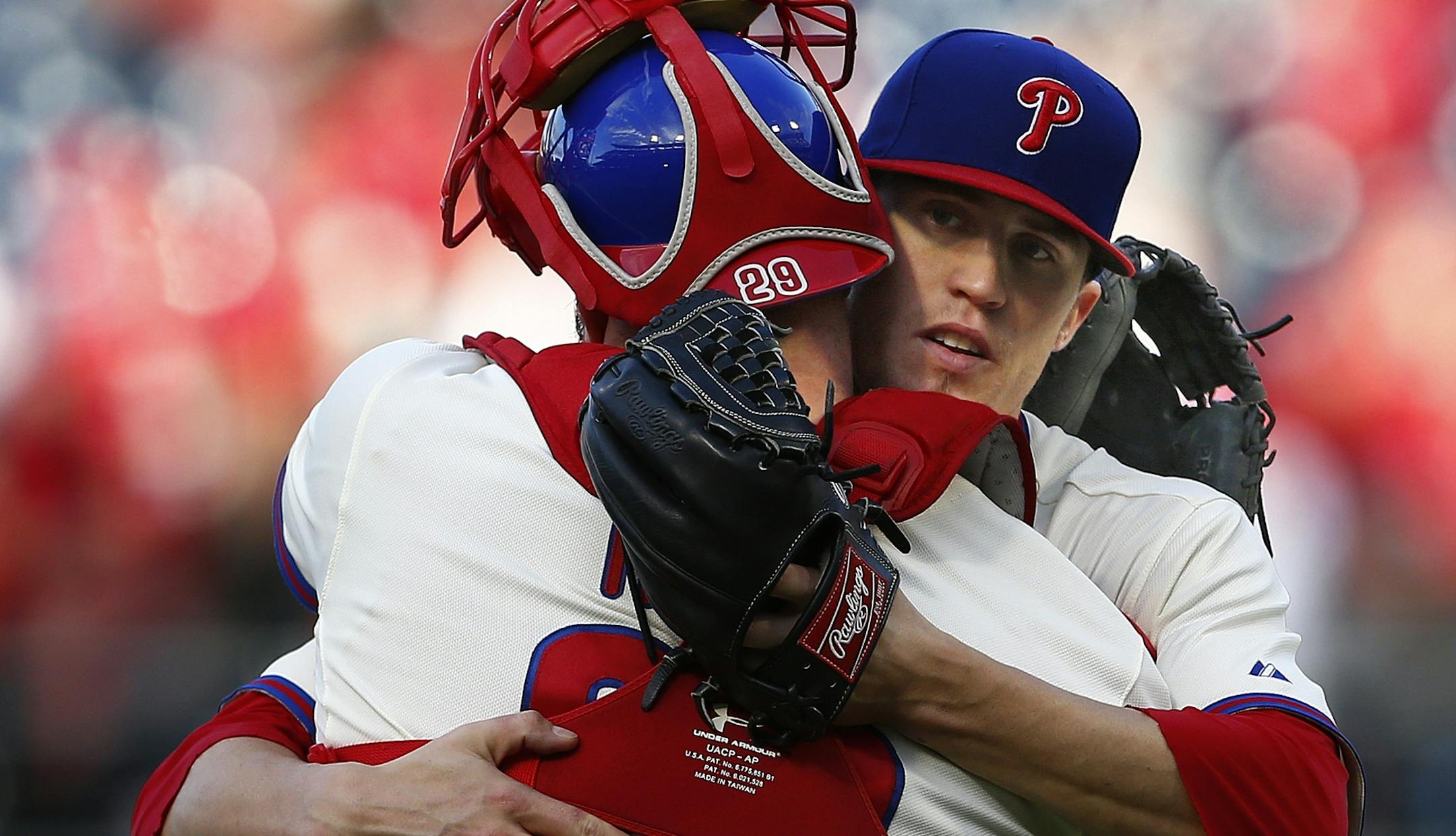 Philadelphia Phillies pitcher Ken Giles (53) hugs catcher Cameron Rupp (29) after getting the final out in the ninth inning against the Miami Marlins during a baseball game, Sunday, Oct. 4, 2015, in Philadelphia. The Phillies defeated the Marlins 7-2. (AP Photo/Rich Schultz)