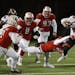 Shakopee RB Jack Casey (44) is tackled by DB Carter Patterson (33).