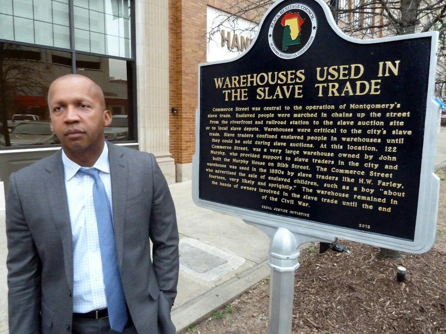 Bryan Stevenson is a Harvard-educated black lawyer who over three decades has worked to help release 115 men from death row, after proving they were prejudicially convicted. Now his nonprofit Equal Justice Initiative in Montgomery, Ala. has a new goal: to place memorial markers at some of the 4,000 lynching sites across the south. Here, Stevenson stands outside the building, where he has erected a sign calling attention to the site's role as a southern slave auction.