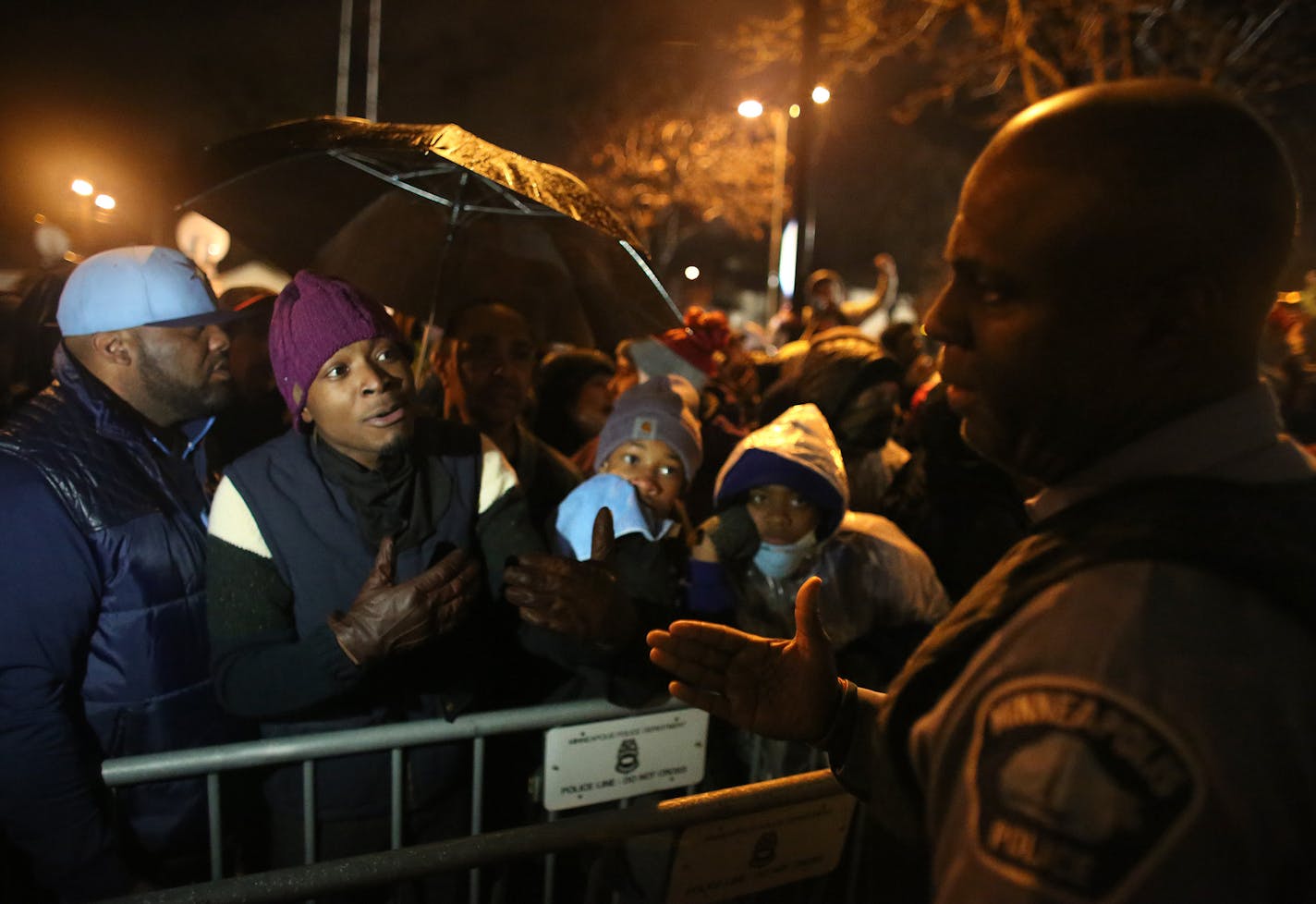 Angry community members loudly questioned an officer who came out to talk about police actions in north Minneapolis. ] (KYNDELL HARKNESS/STAR TRIBUNE) kyndell.harkness@startribune.com Black Lives Matter protested in front of Minneapolis Fourth Precinct in Minneapolis Min., Wednesday November 18, 2015.