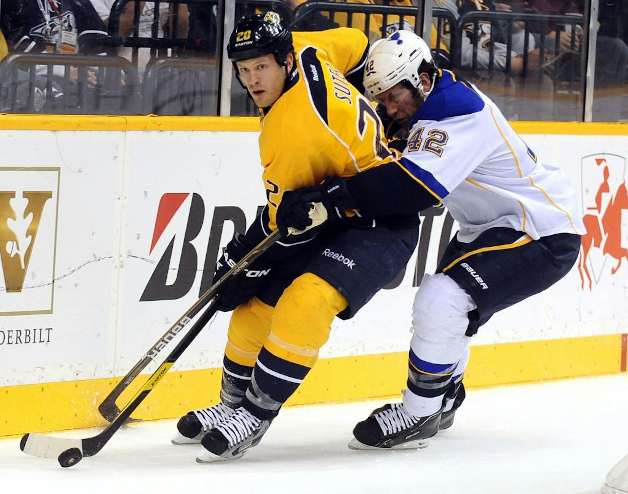 Nashville Predators defenseman Ryan Suter (20) is controls the puck under pressure from St. Louis Blues center David Backes (42) in the first period of an NHL hockey game on Thursday, Feb. 23, 2012, in Nashville, Tenn.