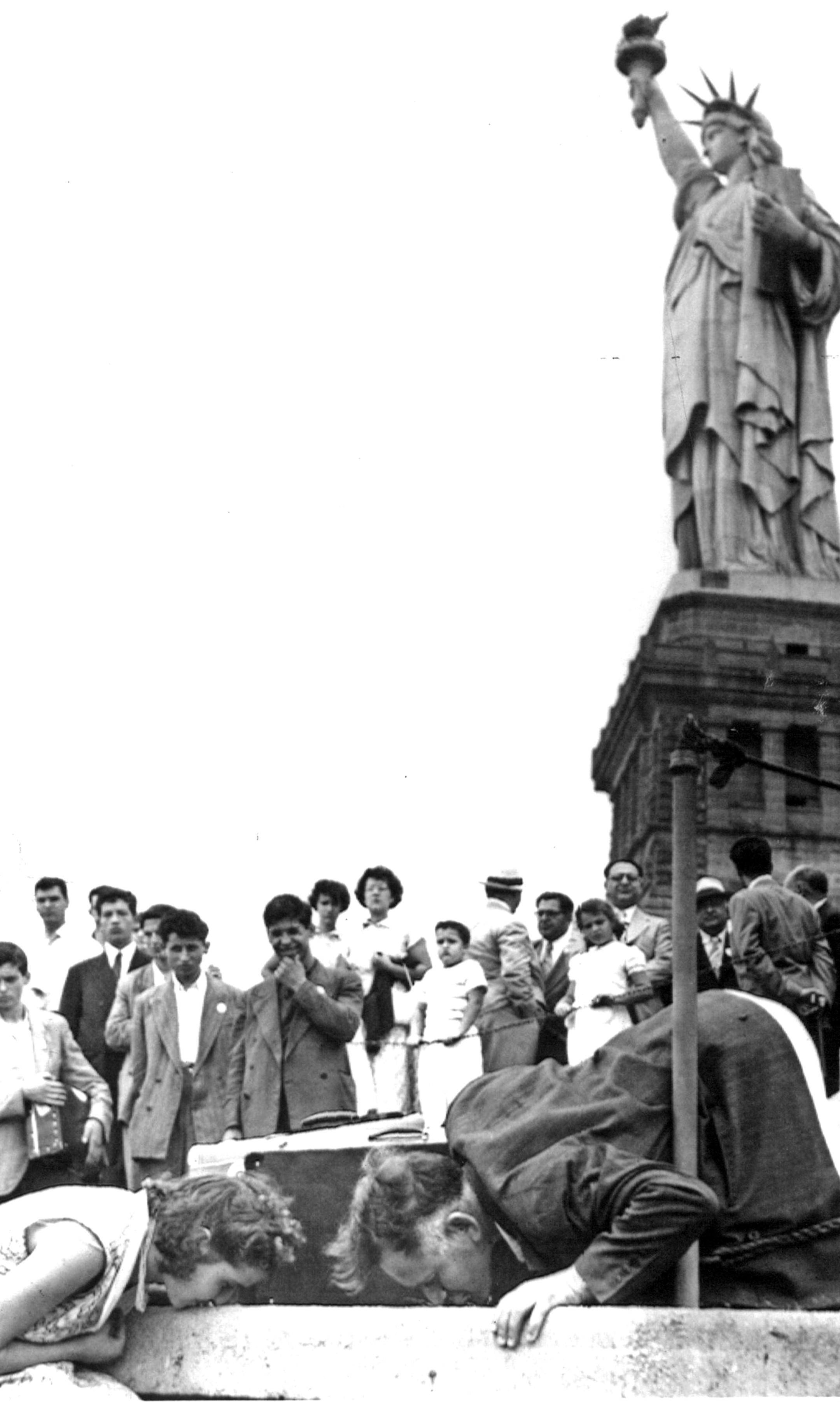 July 17, 1951 'Land of Liberty' The wish of 32 displaced persons from Greece was , granted when United States immigration authorities, for the first time in history, allowed immigrants to set foot on United States soil via Bedloe island where the Statue of Liberty stands. Here two of the displaced persons kiss the soil while the others watch. Ordinarily, the first stop for displaced persons is Ellis island, the processing point for immigrants. ACME; Minneapolis Star Tribune