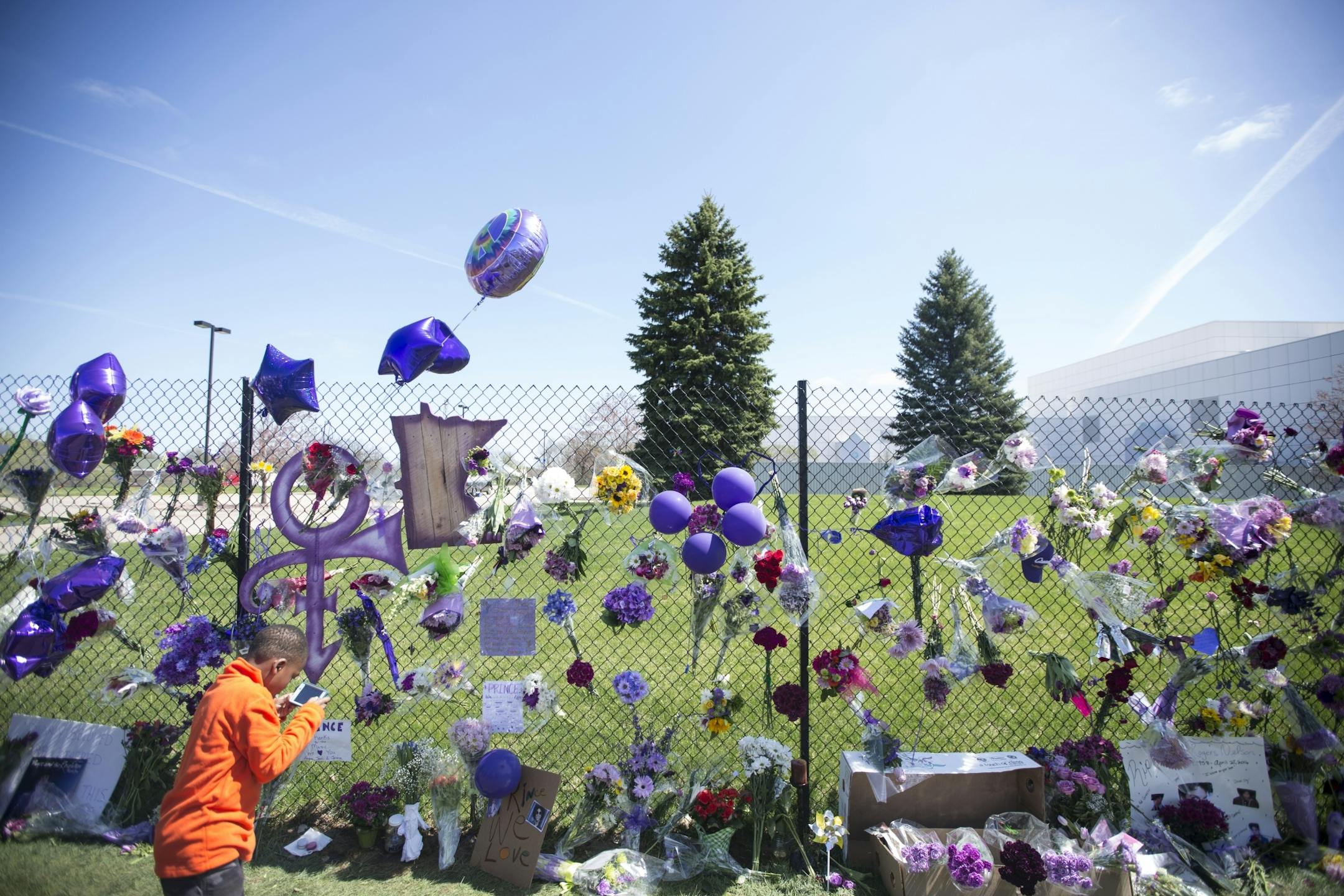 The memorial for Prince set up on the fence outside his home at Paisley Park on Friday, April 22, 2016, in Chanhassen, Minn..