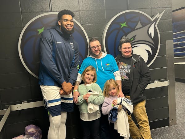 Wolves star Karl-Anthony Towns posed with Andi Otto, Twin Cities Pride executive director, center, as well as Otto’s spouse Dana on the right and da