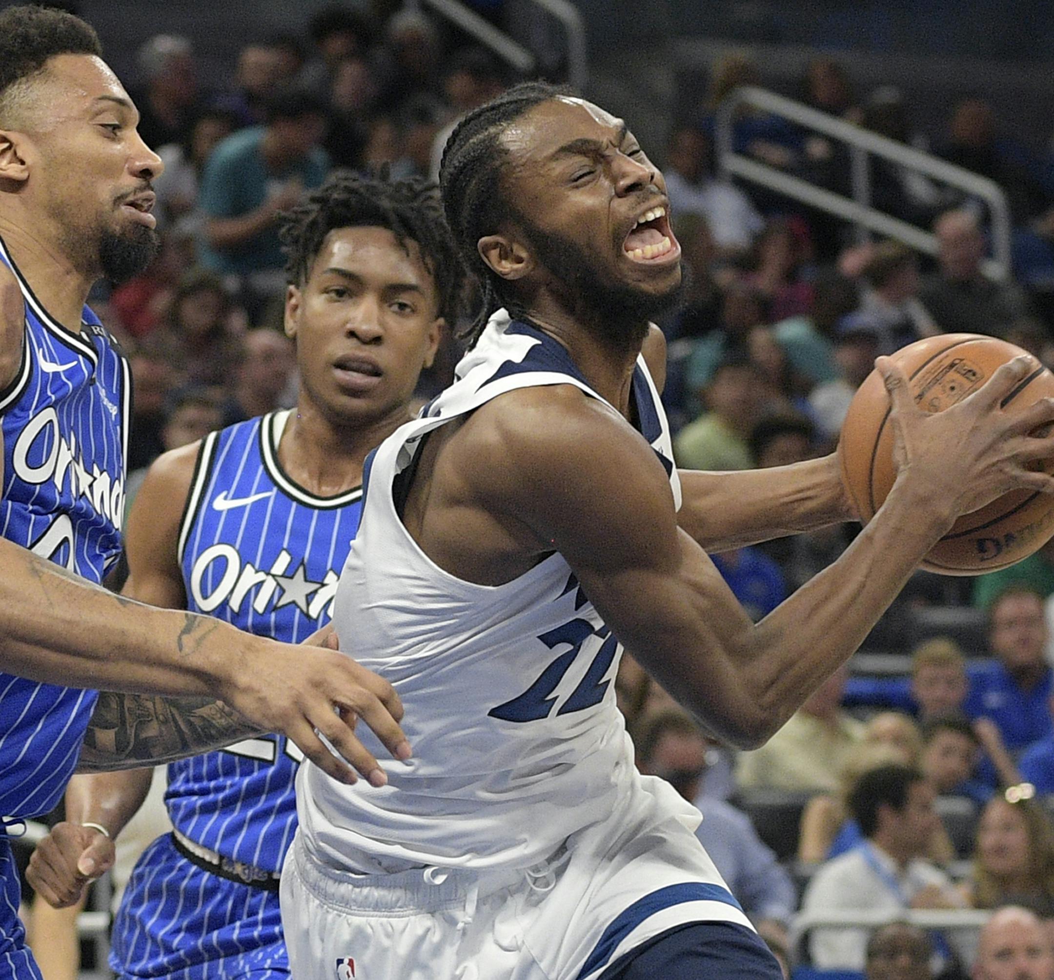 Minnesota Timberwolves forward Andrew Wiggins (22) is fouled by Orlando Magic center Khem Birch, left, while driving to the basket during the first half of an NBA basketball game Thursday, Feb. 7, 2019, in Orlando, Fla. (AP Photo/Phelan M. Ebenhack)