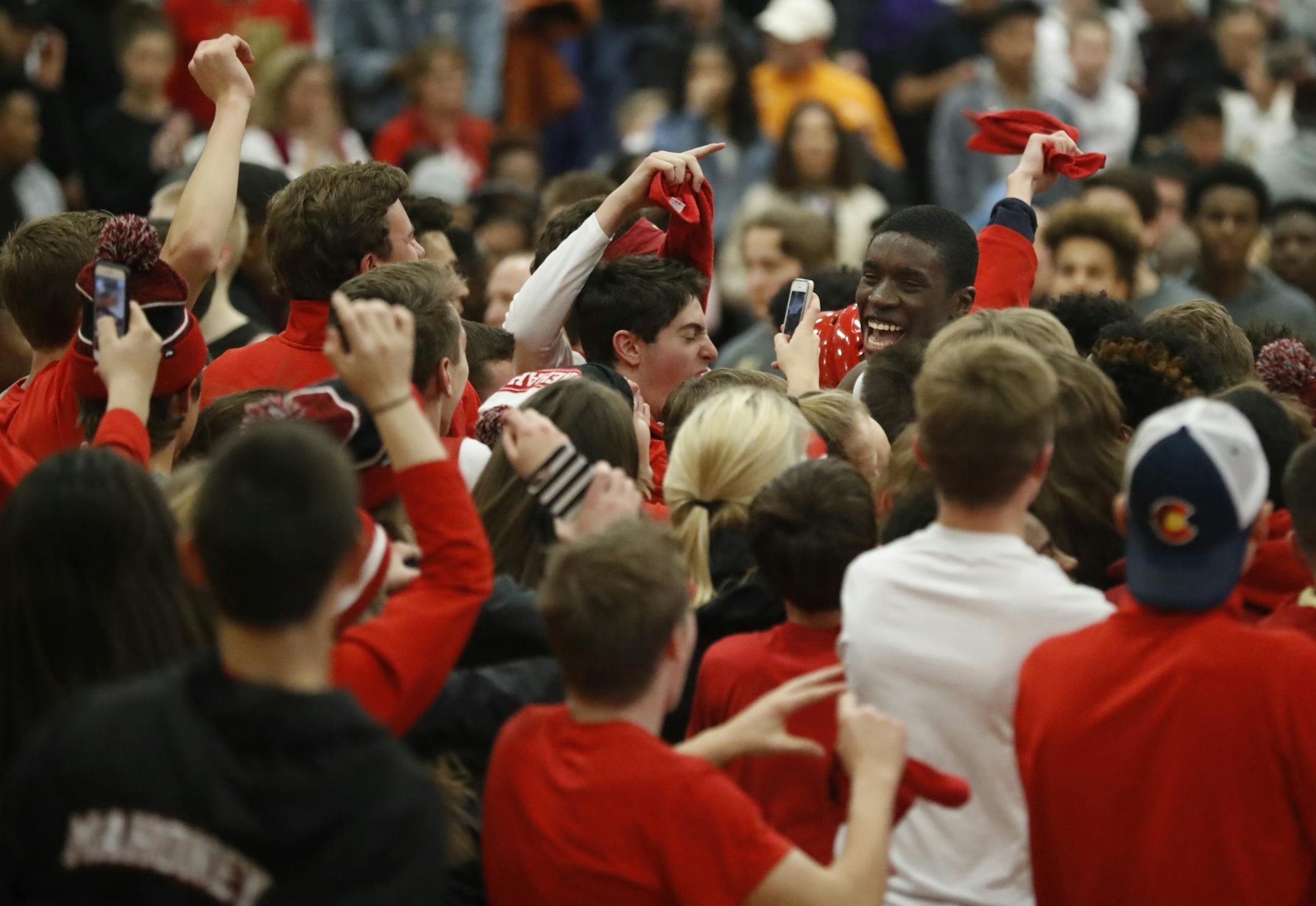 Minnehaha celebrates the win with students rushing the court.