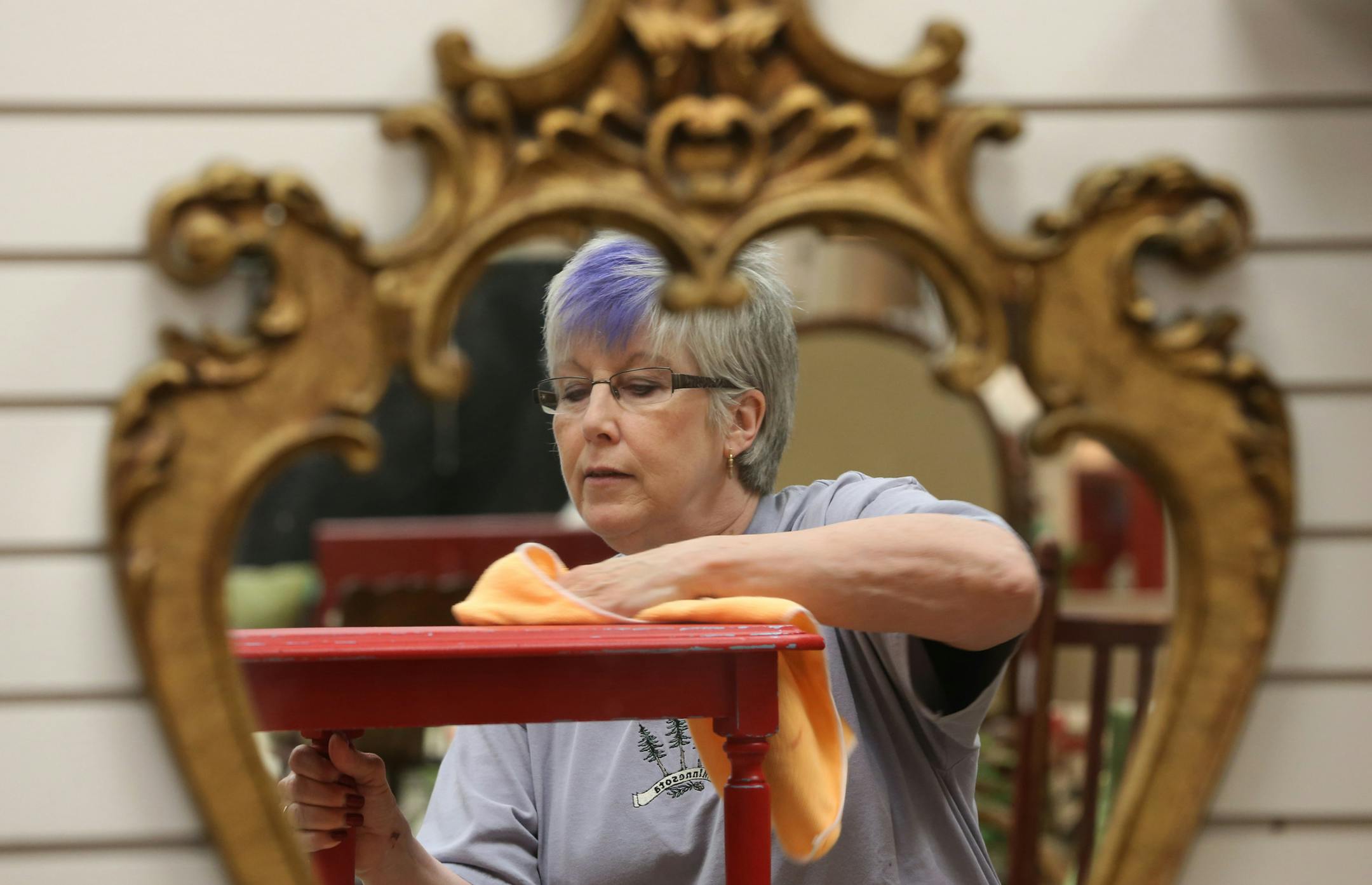 (left to right) Instructor Patti Peltz demonstrated how to refinish furniture to her class, at the Next Act furniture store in Apple Valley on 7/26/13. Two sisters who opened Next Act in Apple Valley, a refurbished furniture shop, are so into "going green" that they teach their customers how to refurbish and paint their own furniture. One sister is the "painter" and the other is the "picker." They typically help young couples take old furniture and give it its "next act" for their starter homes.