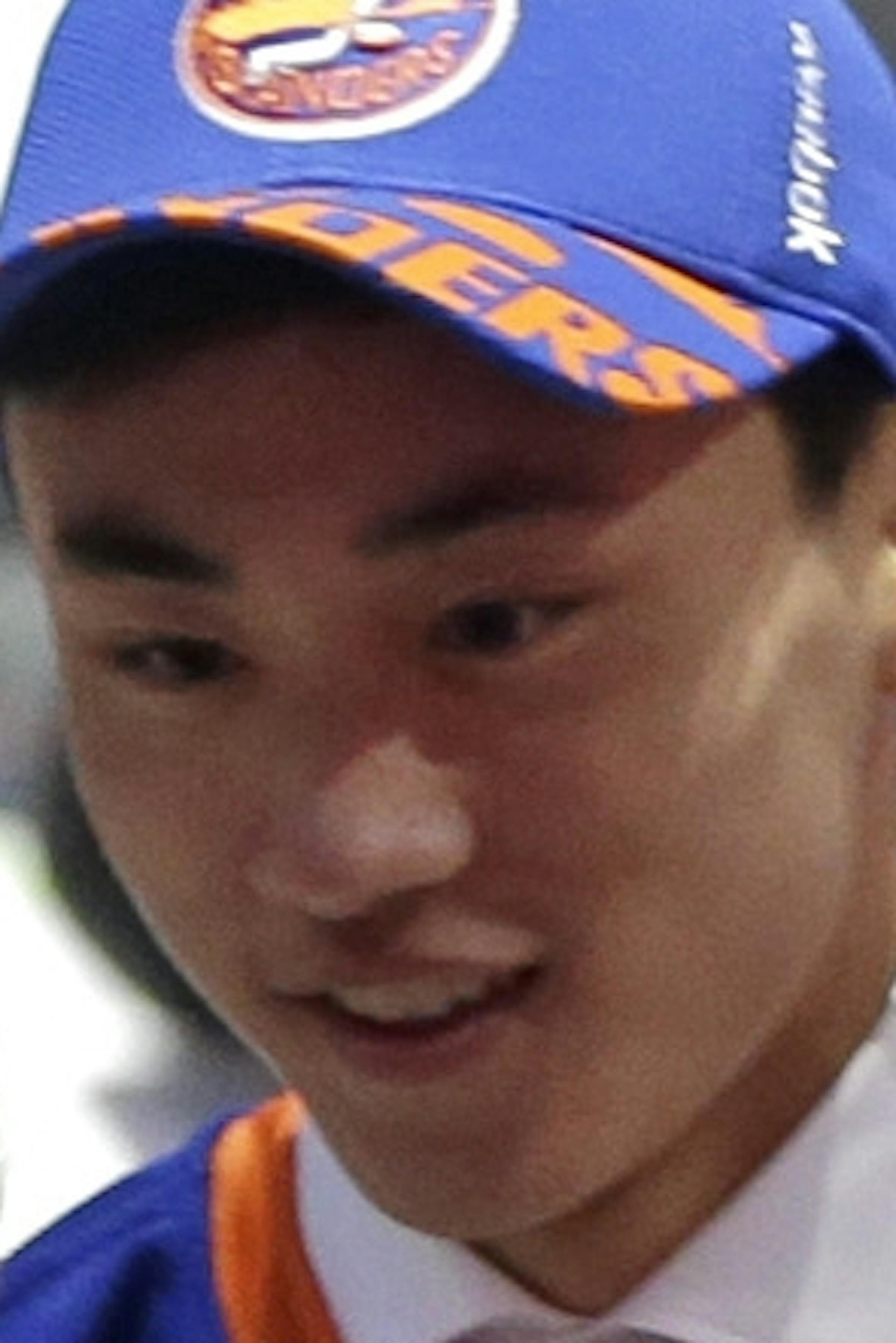 Andong Song, center, of China, shakes hand withe team executives after being chosen 172nd overall by the New York Islanders during the sixth round of the NHL hockey draft, Saturday, June 27, 2015, in Sunrise, Fla. (AP Photo/Alan Diaz)