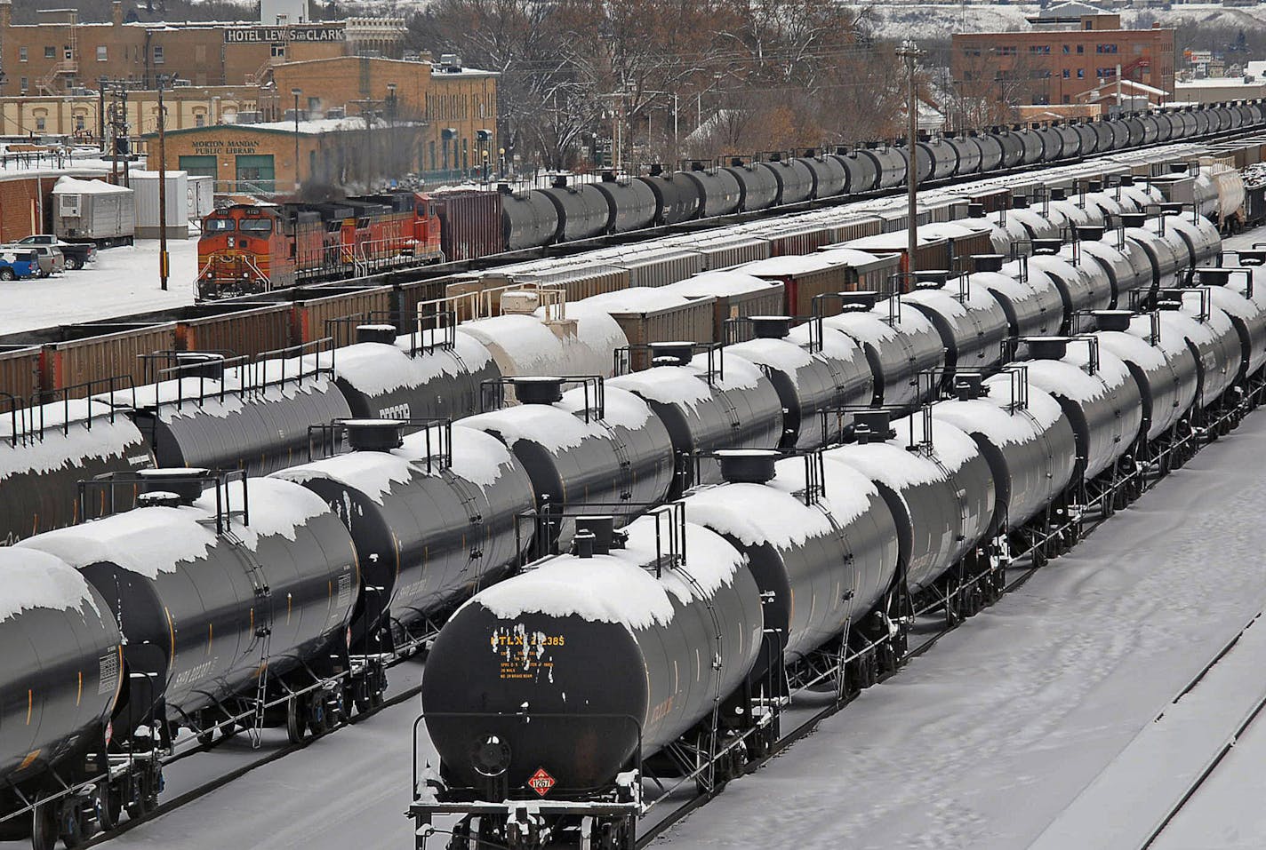 Rail cars are backed up in the yard in the aftermath of a train derailment, Tuesday, Dec. 31, 2013 in Mandan, N.D. A fiery oil train derailment's near-miss of a small North Dakota town had its mayor angrily calling for federal officials to do more to guarantee the safety of the nation's growing shipment of oil by rail. (AP Photo/The Bismarck Tribune, Tom Stromme)