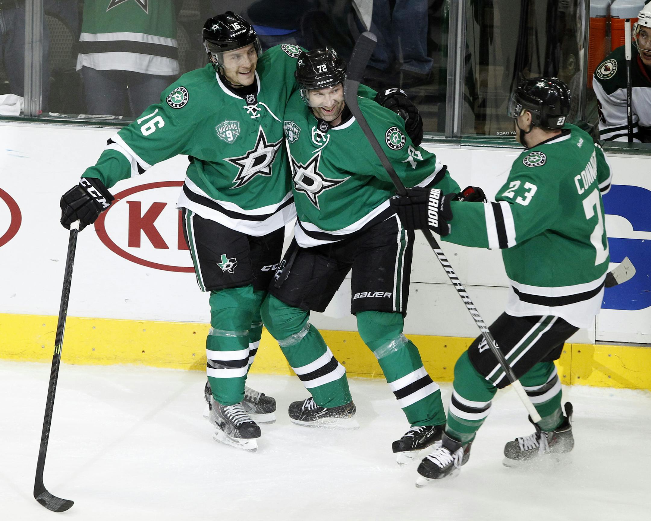 Dallas Stars' Ryan Garbutt (16), Erik Cole (72) and Kevin Connauton (23) celebrate Cole's third-period goal against the Minnesota Wild during an NHL hockey game in Dallas Saturday, March 8, 2014. The Stars won 4-3. (AP Photo/Richard W. Rodriguez)
