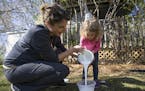 Krista Uderman, left and her daughter Brooklyn pour paint into a bucket for Janet Nelson's porch.]
TONY SAUNDERS &#xb0; anthony.saunders@startribune.c