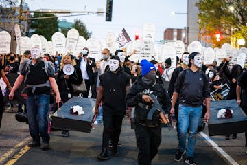 Families of those killed by police marched with hundreds of supporters in "The Secret March" down University Avenue to the Capitol in St. Paul.