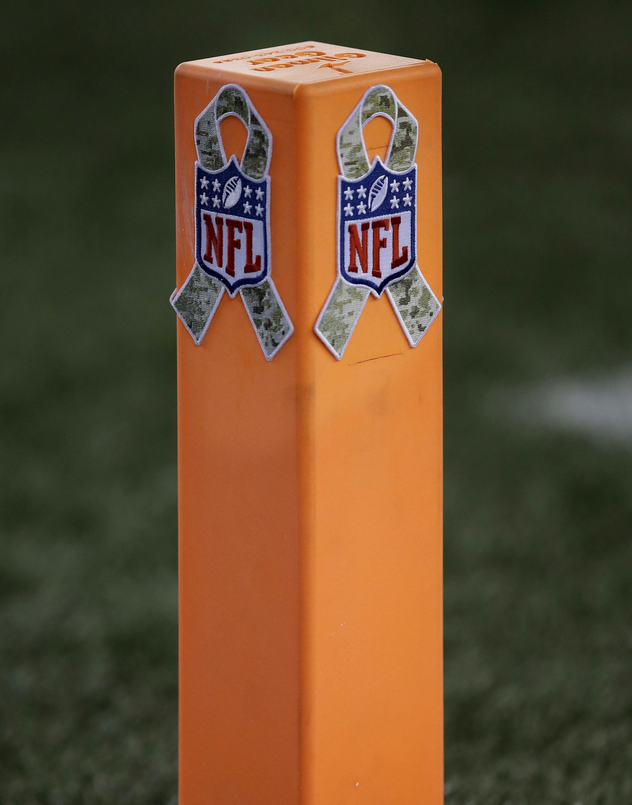 A pylon is decorated with military camouflage as part of the Salute to Service military appreciation campaign during the first half of an NFL football game between the New England Patriots and the Seattle Seahawks, Sunday, Nov. 13, 2016, in Foxborough, Mass. (AP Photo/Charles Krupa) ORG XMIT: FBO101