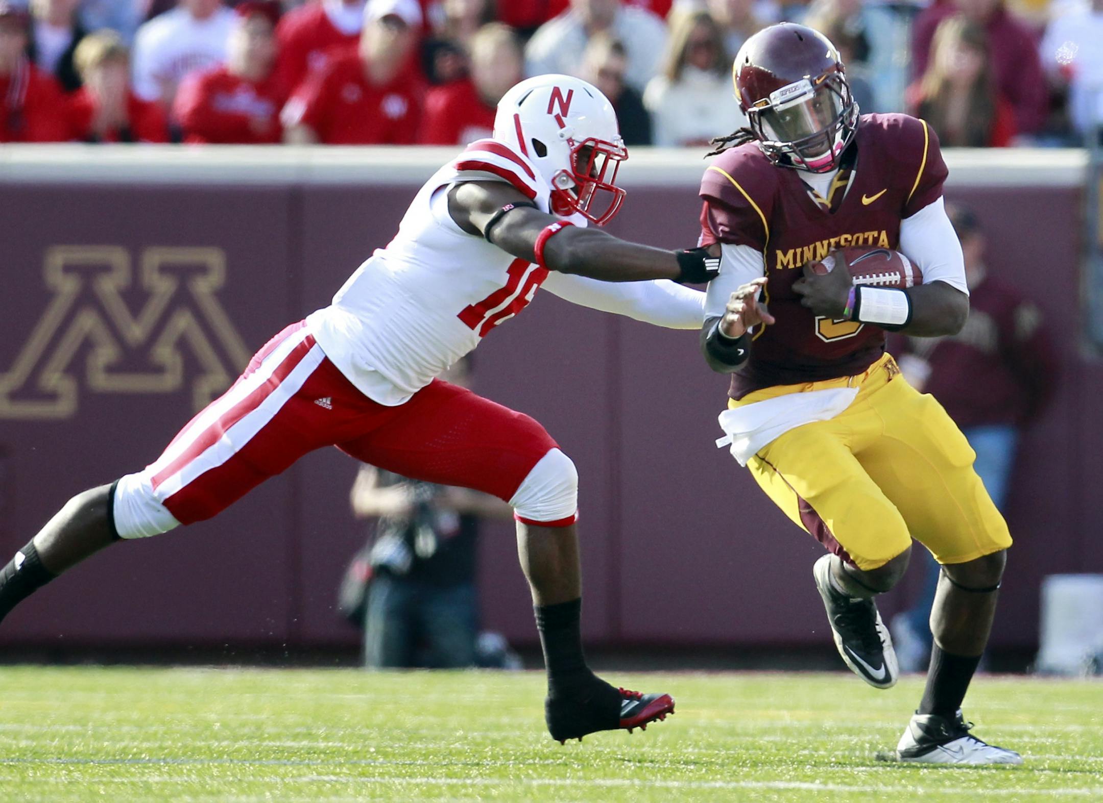 Marquis Gray (5) was pushed out of bounds by Stanley Jean-Baptiste (16) in the first quarter.
