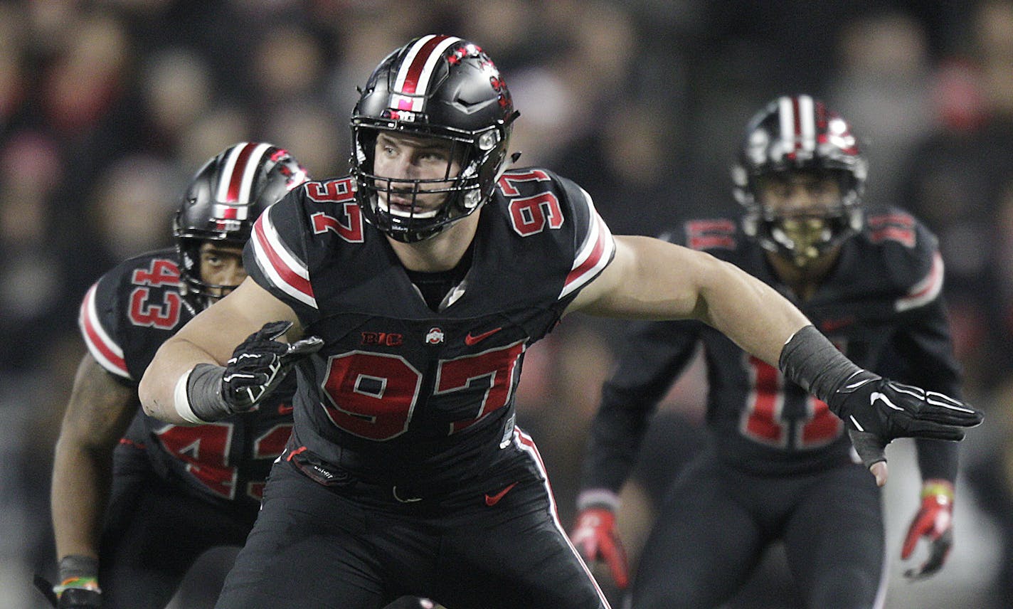 FILE - In this Oct. 17, 2015, file photo, Ohio State defensive lineman Joey Bosa plays against Penn State during an NCAA college football game, in Columbus, Ohio. The junior is expected to enter the 2016 NFL draft and will likely play his last game in Ohio Stadium when Ohio State plays Saturday against No. 9 Michigan State.(AP Photo/Jay LaPrete, File) ORG XMIT: NY174