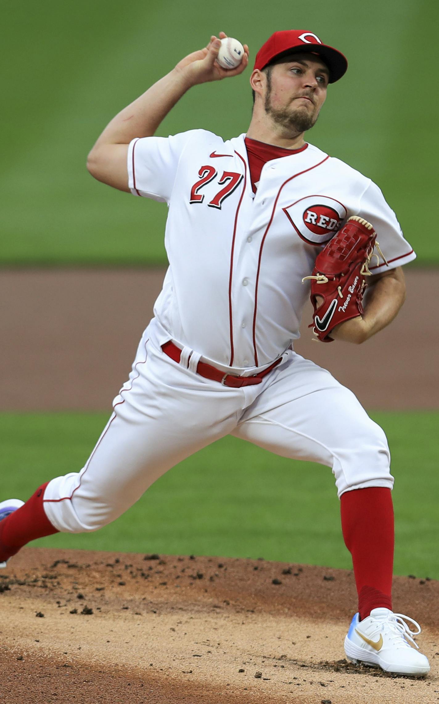 Cincinnati Reds' Trevor Bauer winds up during the first inning of the team's baseball game against the Milwaukee Brewers in Cincinnati, Wednesday, Sept. 23, 2020. (AP Photo/Aaron Doster)