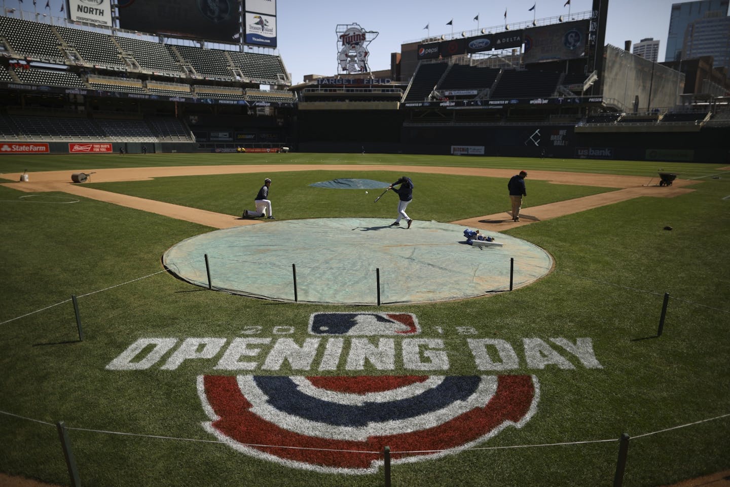 Twins players caught fly balls as the grounds crew began final preparations for Thursday's home opener.