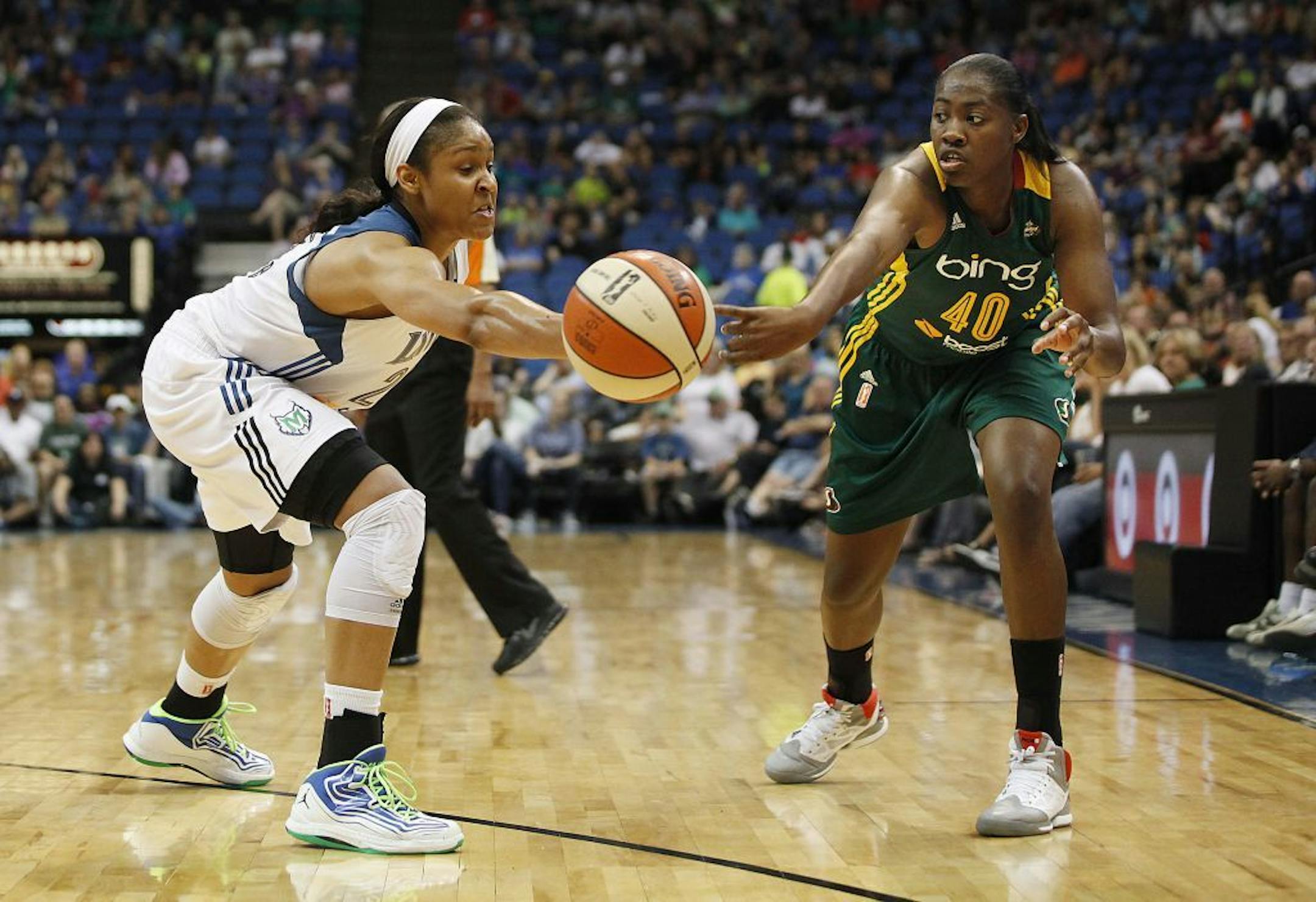Minnesota Lynx forward Maya Moore (23) knocks away a pass made by Seattle Storm guard Shekinna Stricklen (40) earlier this season.