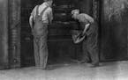 Two men were at work in the Minneapolis Threshing Machine Co. foundry in 1915.