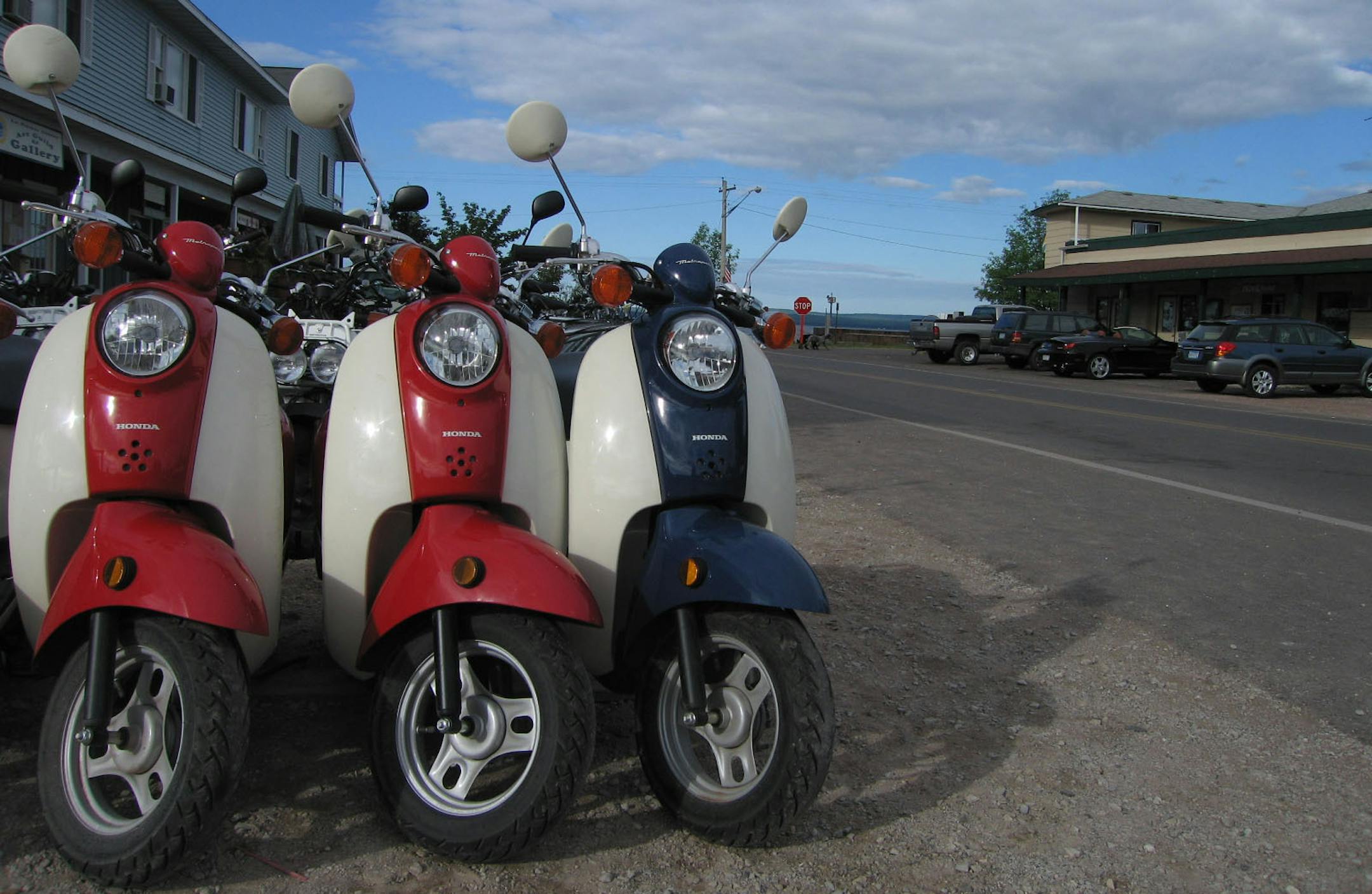 Motion to Go in La Pointe, Wis., top, rents mopeds and bikes. The Madeline Island Historic Museum, bottom, is housed in several historic buildings.