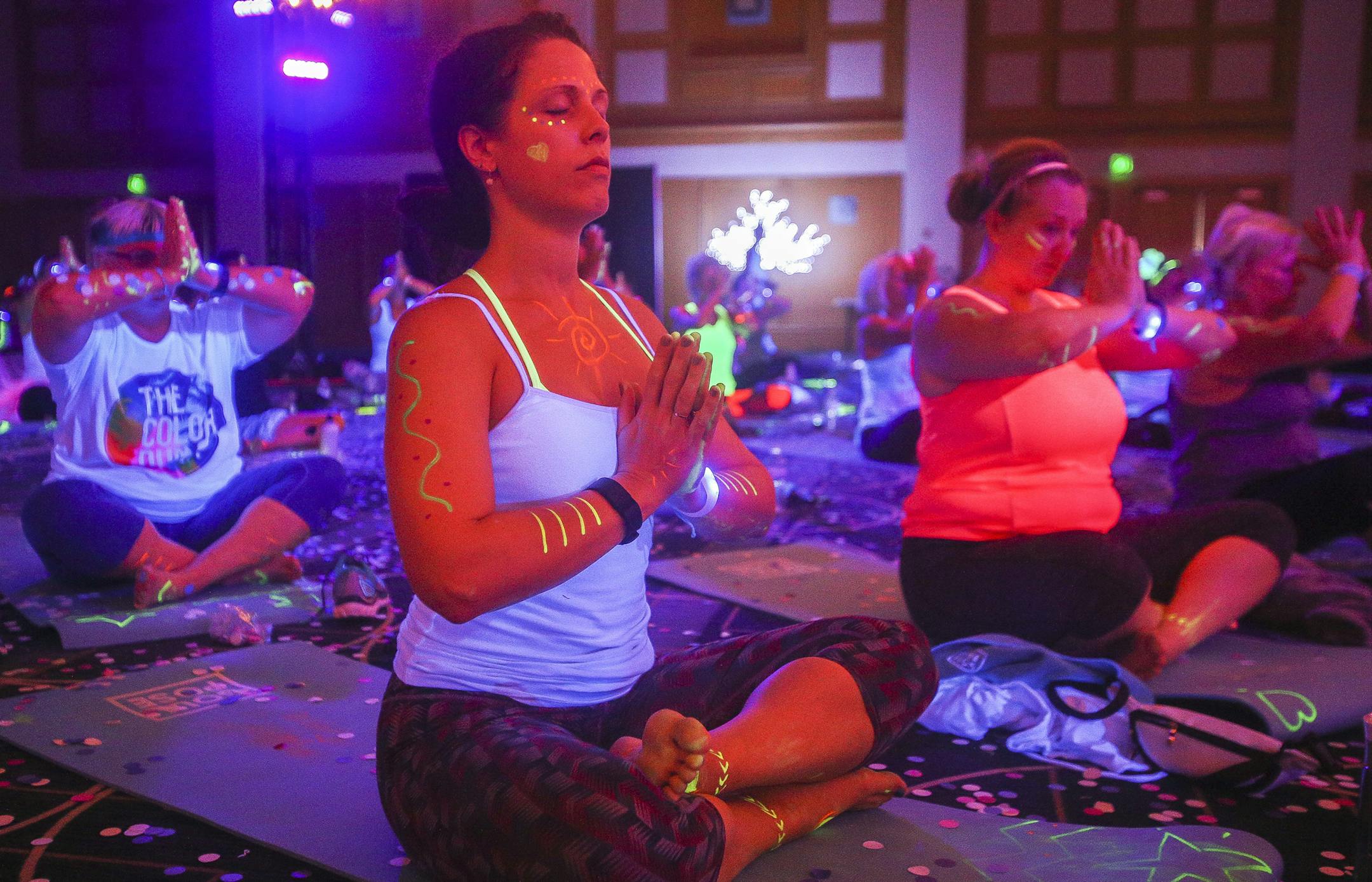 Brenda Talarico of Roseville takes a moment to decompress at the end of the yoga session. ] Timothy Nwachukwu • timothy.nwachukwu@startribune.com Participants found their inner peace under blacklights Saturday morning during Soul Pose at the Minneapolis Convention Center on August 6, 2016. Soul Pose is a blacklight yoga party, where folks do yoga in a dark, glowing room with music.