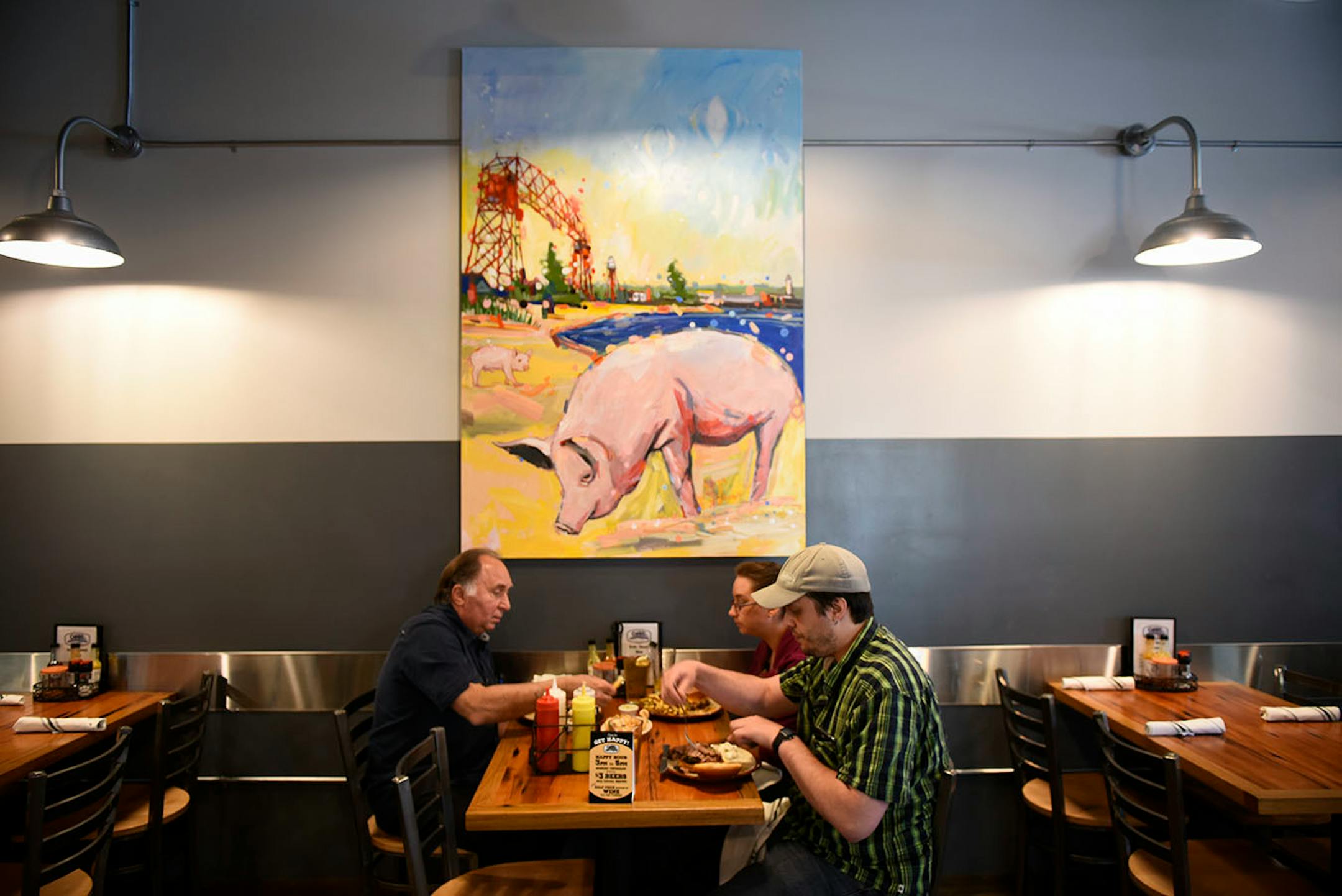 Russ Kalina, left, of Minneapolis, his daughter, Laurie Kalina and her boyfriend, Benjamin Christian, both from Two Harbors, ate lunch at OMC Smokehouse Thursday afternoon.