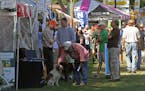 Dogs and their owners walked through the display booths at at a previous Game Fair.