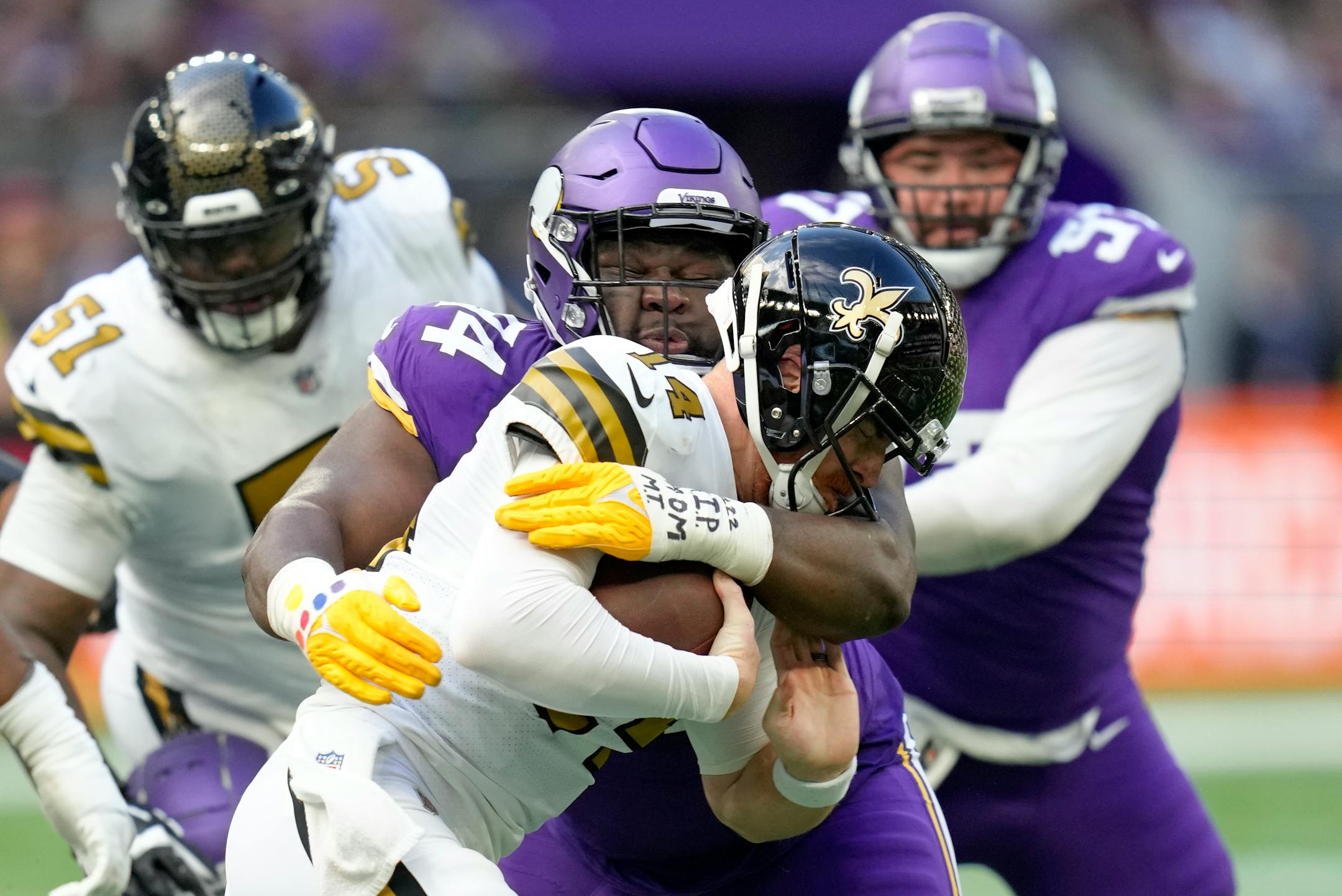 New Orleans Saints quarterback Andy Dalton (14) is sacked by Minnesota Vikings defensive tackle Dalvin Tomlinson (94).