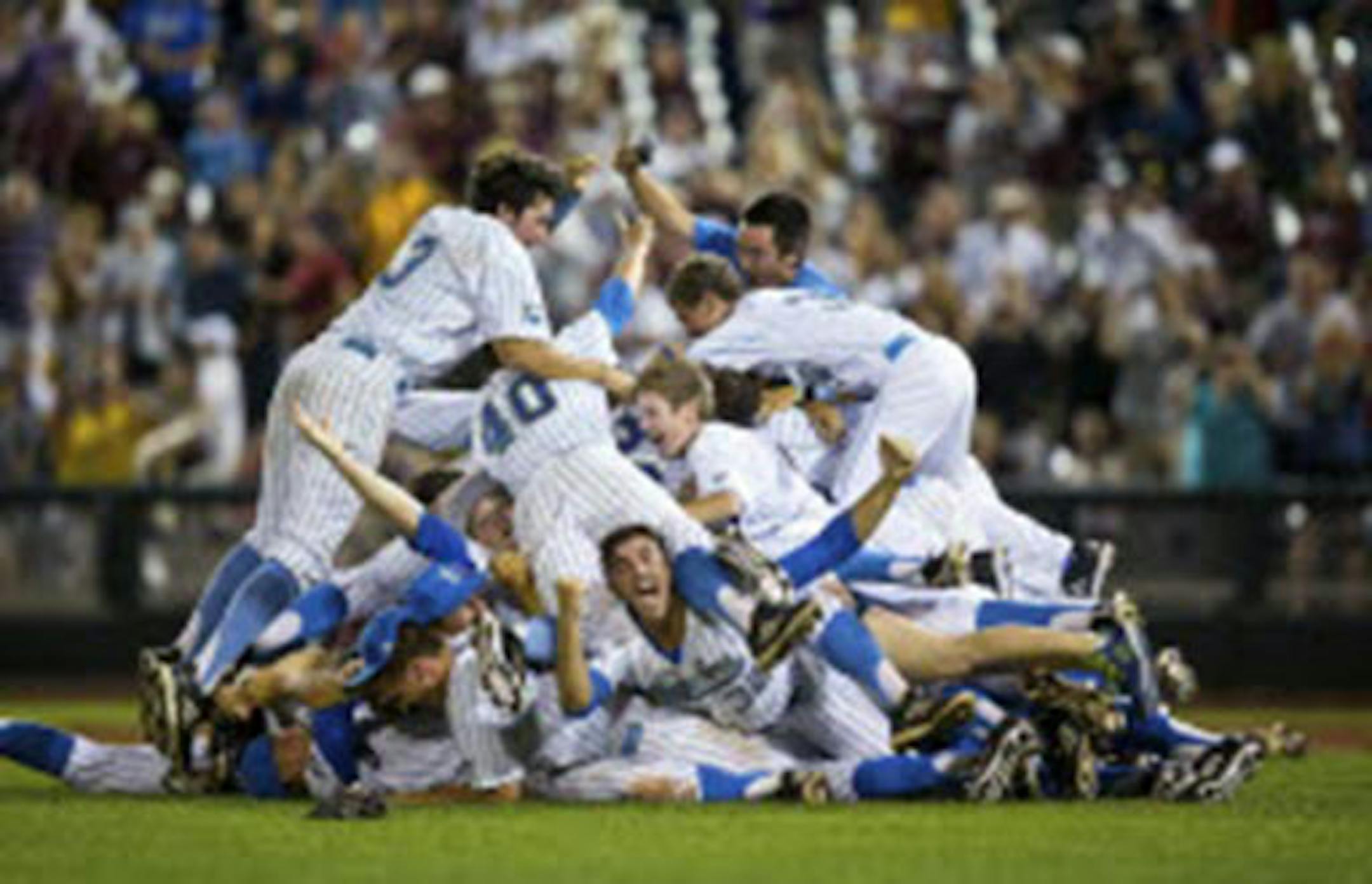 UCLA's Zack Weiss (32) pumped his fist at the bottom of the UCLA dog pile after UCLA defeated Mississippi State 8-0 in Game 2 to win the College World Series championship Tuesday.