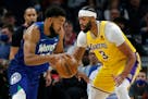 Timberwolves center Karl-Anthony Towns works past Lakers forward Anthony Davis in the first quarter Friday night.