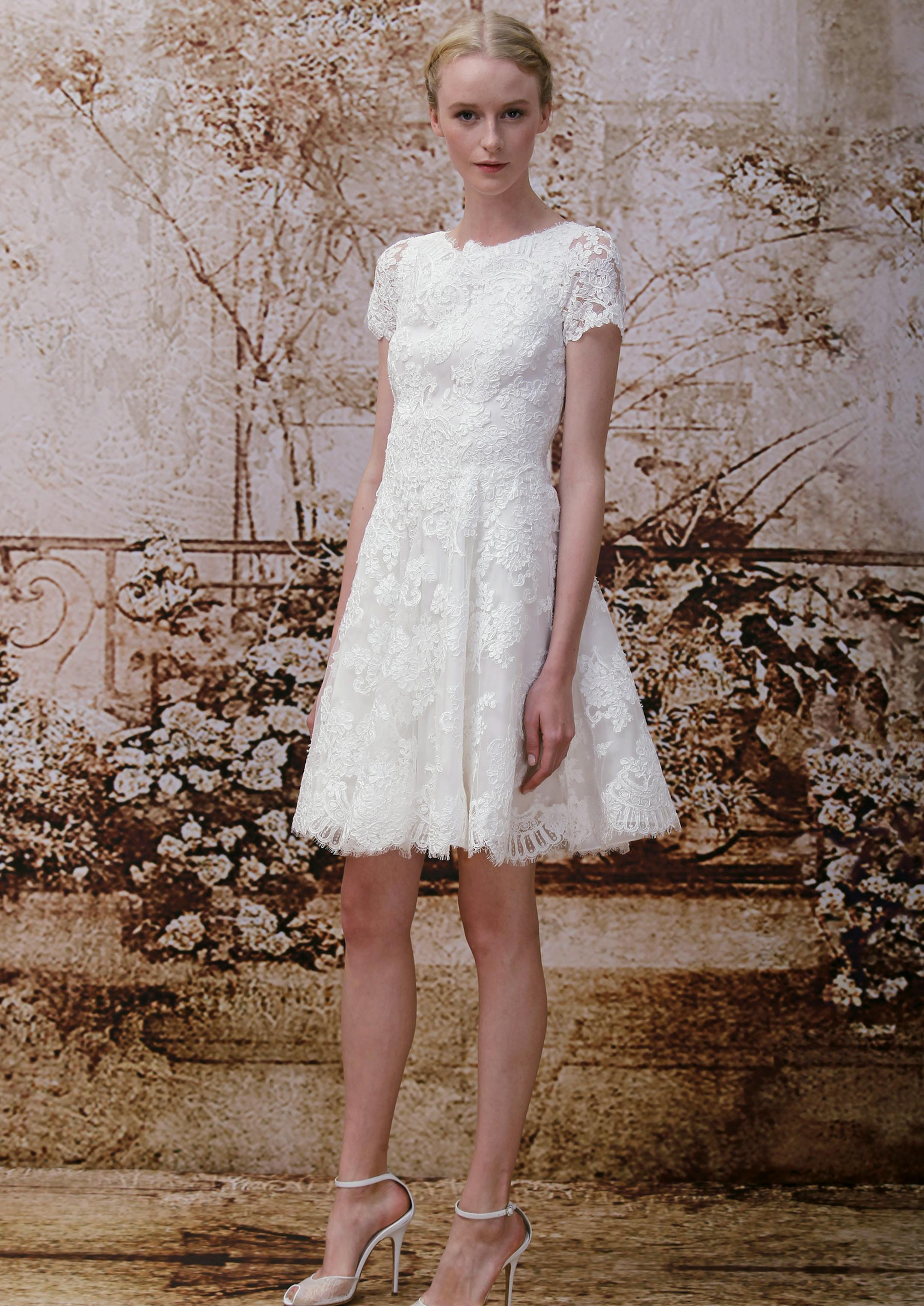 This 2013 image released by the Monique Lhuillier fashion house shows the Opal, a silk white re-embroidered lace short-sleeved mini-wedding dress. "A lot of people are doing more intimate settings, so a shorter dress just feels more appropriate. If they do the big wedding, some change into a shorter dress so they can dance and have a good time," designer Monique Lhuillier said. (AP Photo/Monique Lhuillier, Dan & Corina Lecca)