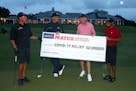 Tiger Woods and former NFL player Peyton Manning celebrate defeating Phil Mickelson and NFL player Tom Brady of the Tampa Bay Buccaneers on the 18th g