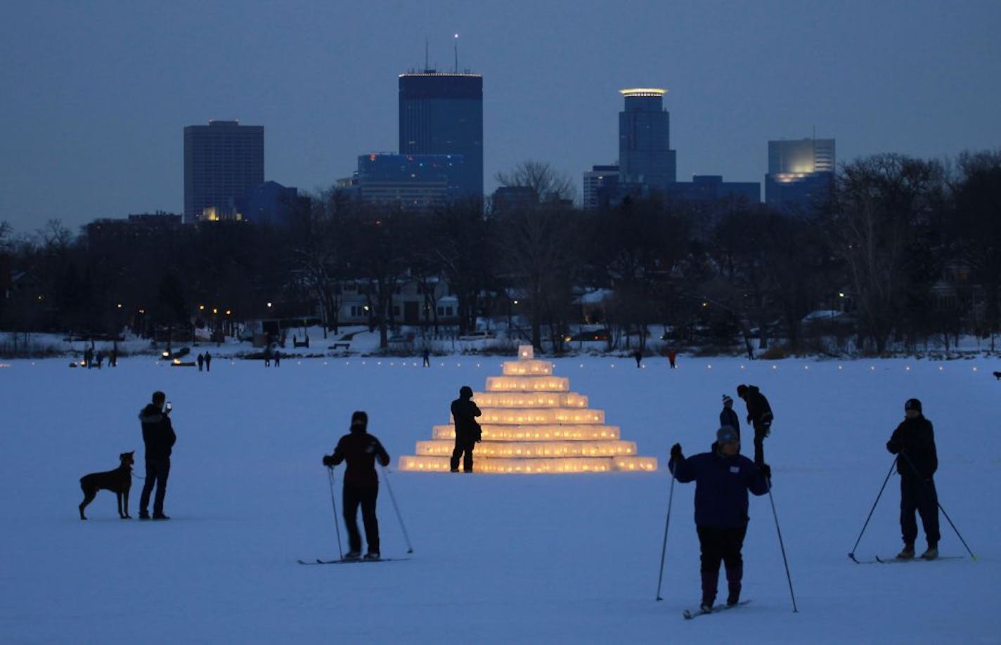 Why do we live here? The scene of Thousands of ice luminarias lighting up the path Saturday evening on Lake of the Isles for those participating in the Luminary Loppet,a two-day cross-country ski festival, and for those just taking in the spectacular Minneapolis scene give you insight to that question.. [ TOM WALLACE • twallace@startribune.com _ Assignments #20027414A_ Feburary 2, 2013_ SLUG: loppet020313.luminary_ EXTRA INFORMATION: