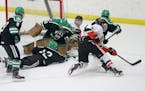 Hill-Murray goalie Remington Keopple (30) makes a save on a shot by White Bear Lake's Max Jennrich (6) with help from teammate Joey Petronack (12) dur