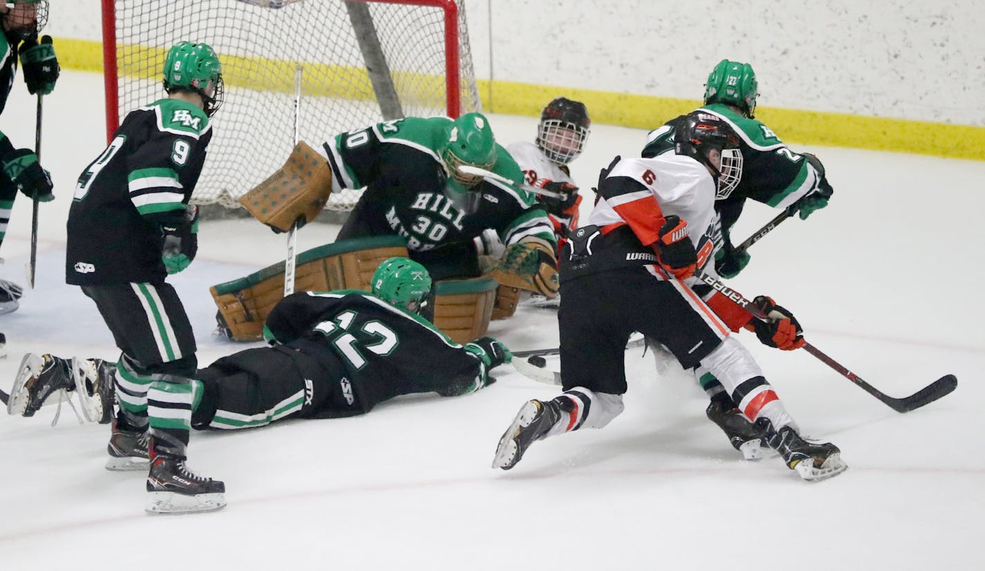 Hill-Murray goalie Remington Keopple (30) makes a save on a shot by White Bear Lake's Max Jennrich (6) with help from teammate Joey Petronack (12) during the third period of Hill-Murray's 3-2 win over White Bear Lake in the Boys' hockey, Class 2A, Section 4 final Friday, March 2, 2018, at Aldrich Arena in Maplewood, MN.]