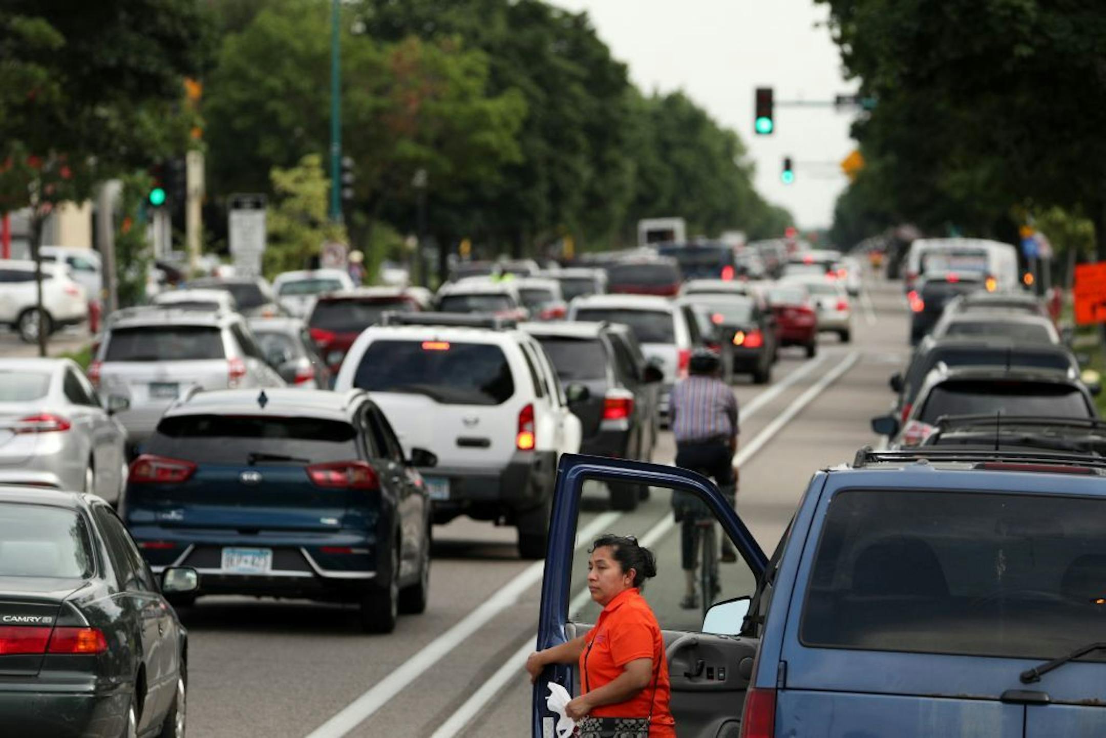 A woman watched as commuters navigated Portland Avenue southbound during the evening rush hour Friday.