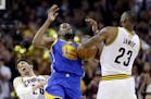 Golden State Warriors forward Kevin Durant (35) and Cleveland Cavaliers forward LeBron James (23) vie for a loose ball during the second half of Game 
