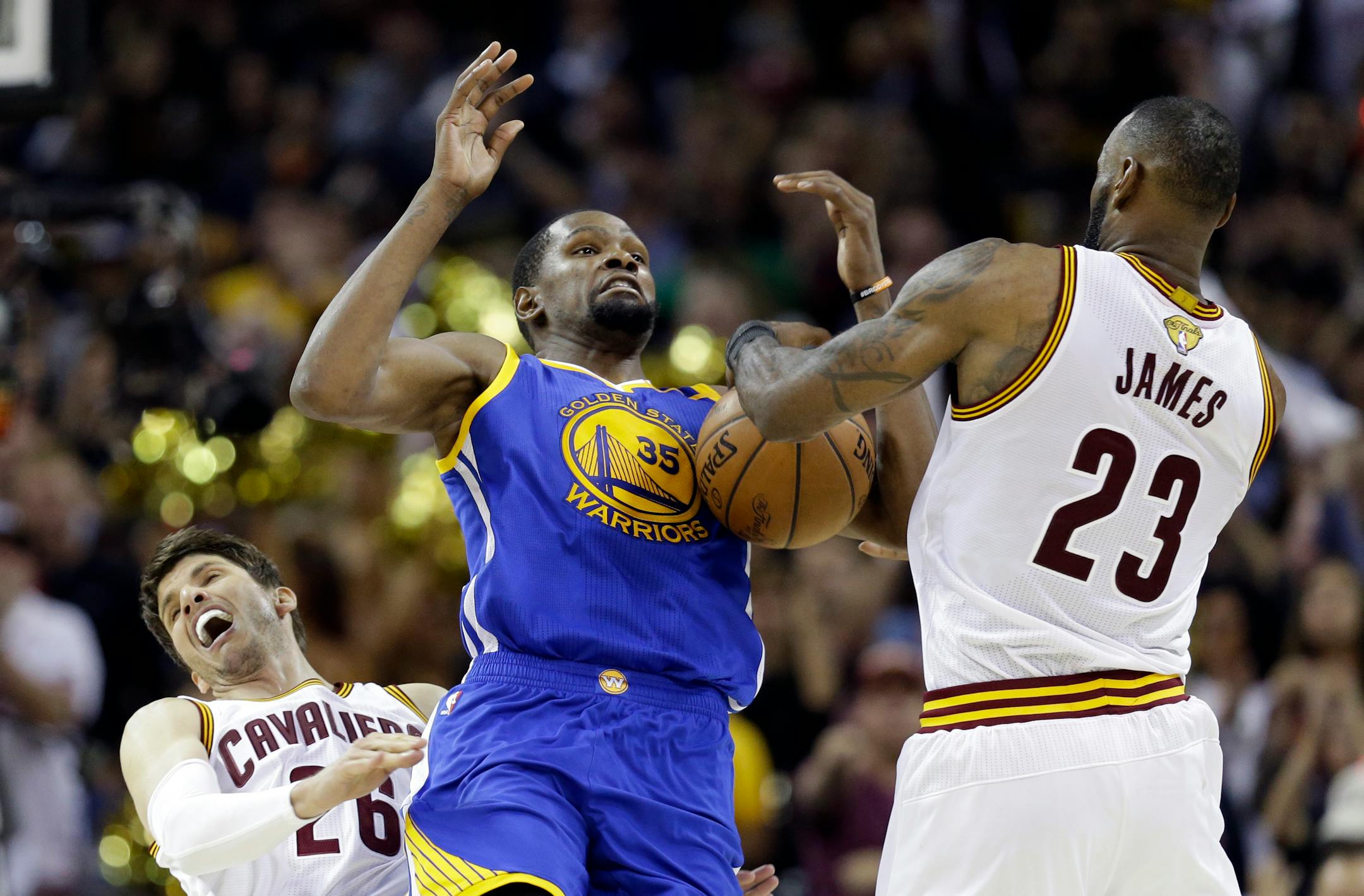 Golden State Warriors forward Kevin Durant (35) and Cleveland Cavaliers forward LeBron James (23) vie for a loose ball during the second half of Game 3 of basketball's NBA Finals in Cleveland, Wednesday, June 7, 2017. The Warriors won 118-113. (AP Photo/Tony Dejak)