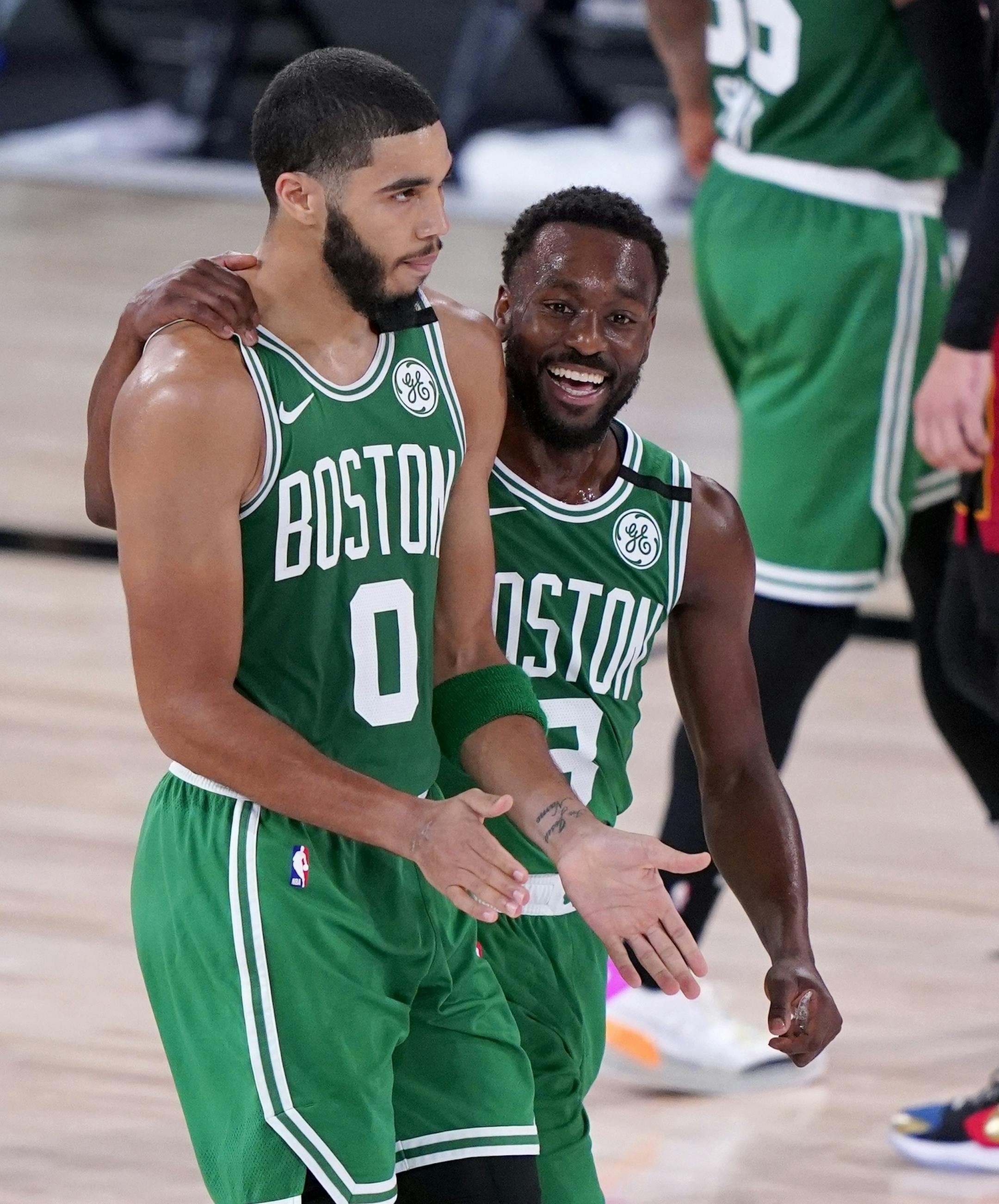Boston Celtics' Jayson Tatum (0) and Kemba Walker (8) walk off the court at the end of the first half of an NBA conference final playoff basketball game against the Miami Heat on Saturday, Sept. 19, 2020, in Lake Buena Vista, Fla. (AP Photo/Mark J. Terrill)
