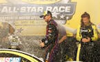 Denny Hamlin celebrates in Victory Lane after winning the NASCAR Sprint All-Star auto race at Charlotte Motor Speedway in Concord, N.C., Saturday, May