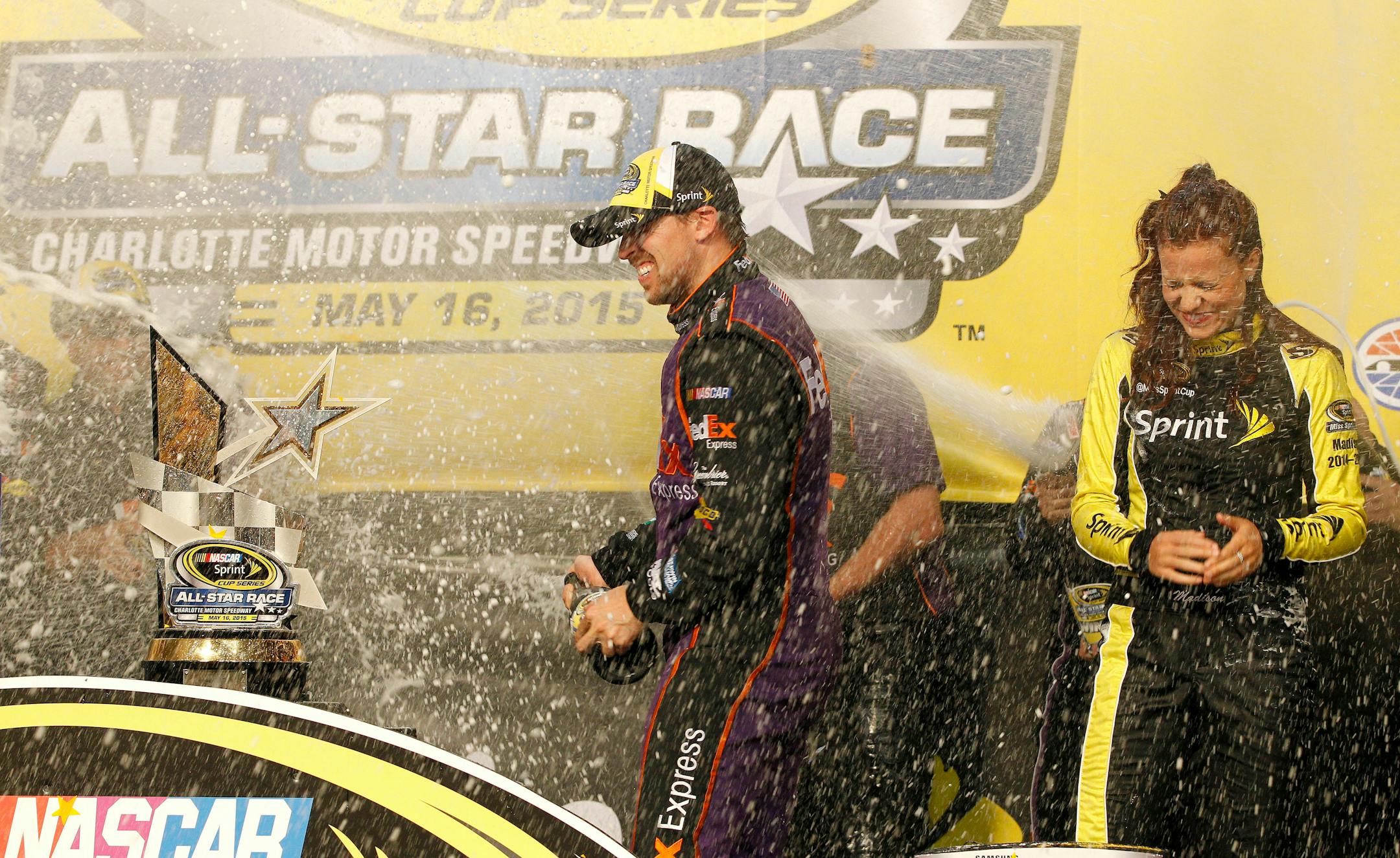 Denny Hamlin celebrates in Victory Lane after winning the NASCAR Sprint All-Star auto race at Charlotte Motor Speedway in Concord, N.C., Saturday, May 16, 2015. (AP Photo/Terry Renna)