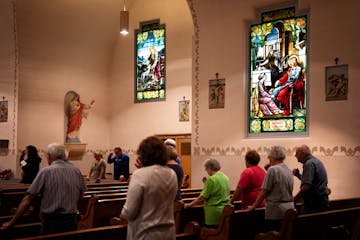 Parishioners did the sign of the cross at the end of Friday Mass at St. Joseph Church.