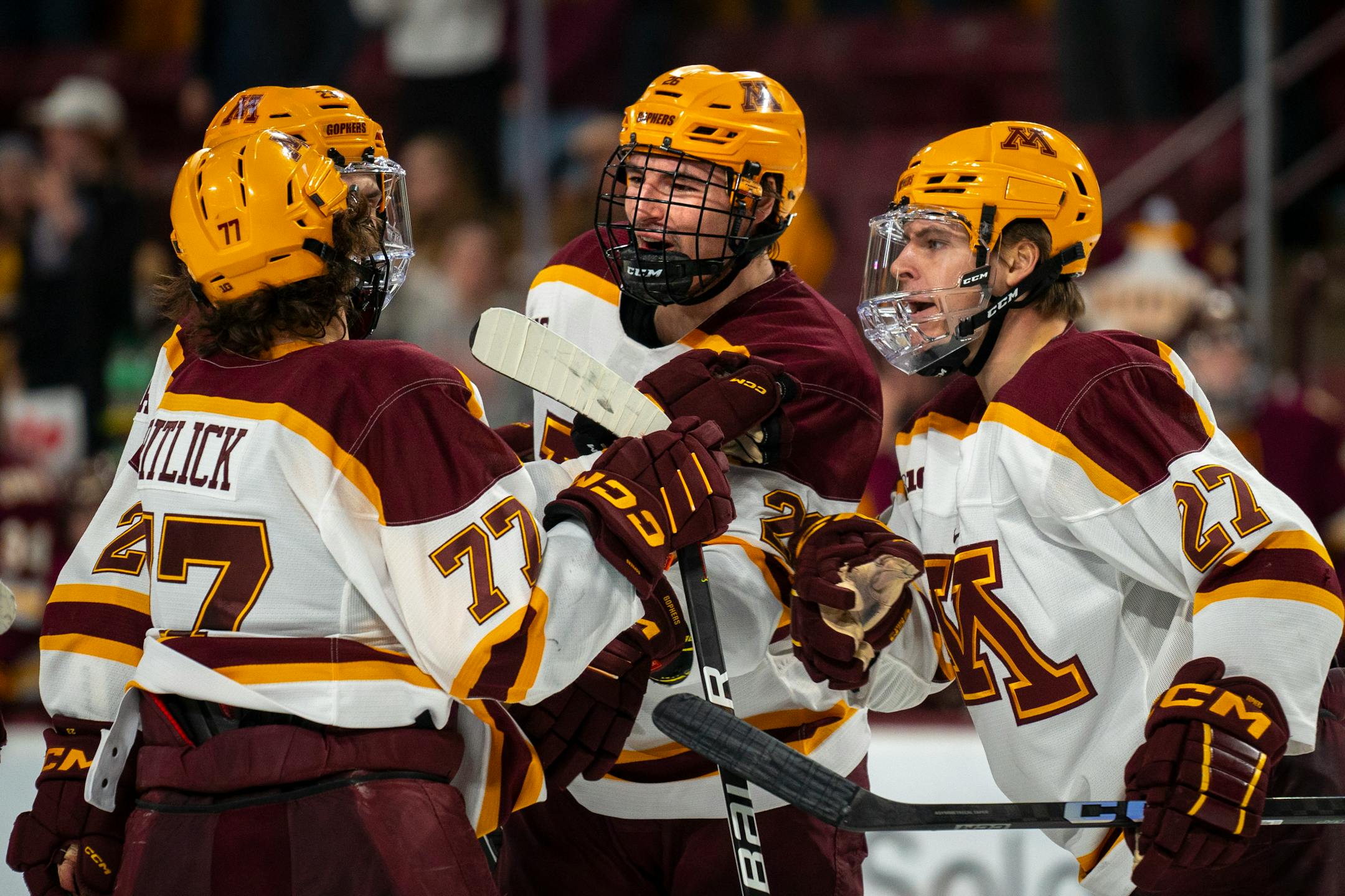 Minnesota players celebrate after their fourth goal, putting them at 4-0. This was Minnesota defenseman Cal Thomas's (6) first goal of his career.