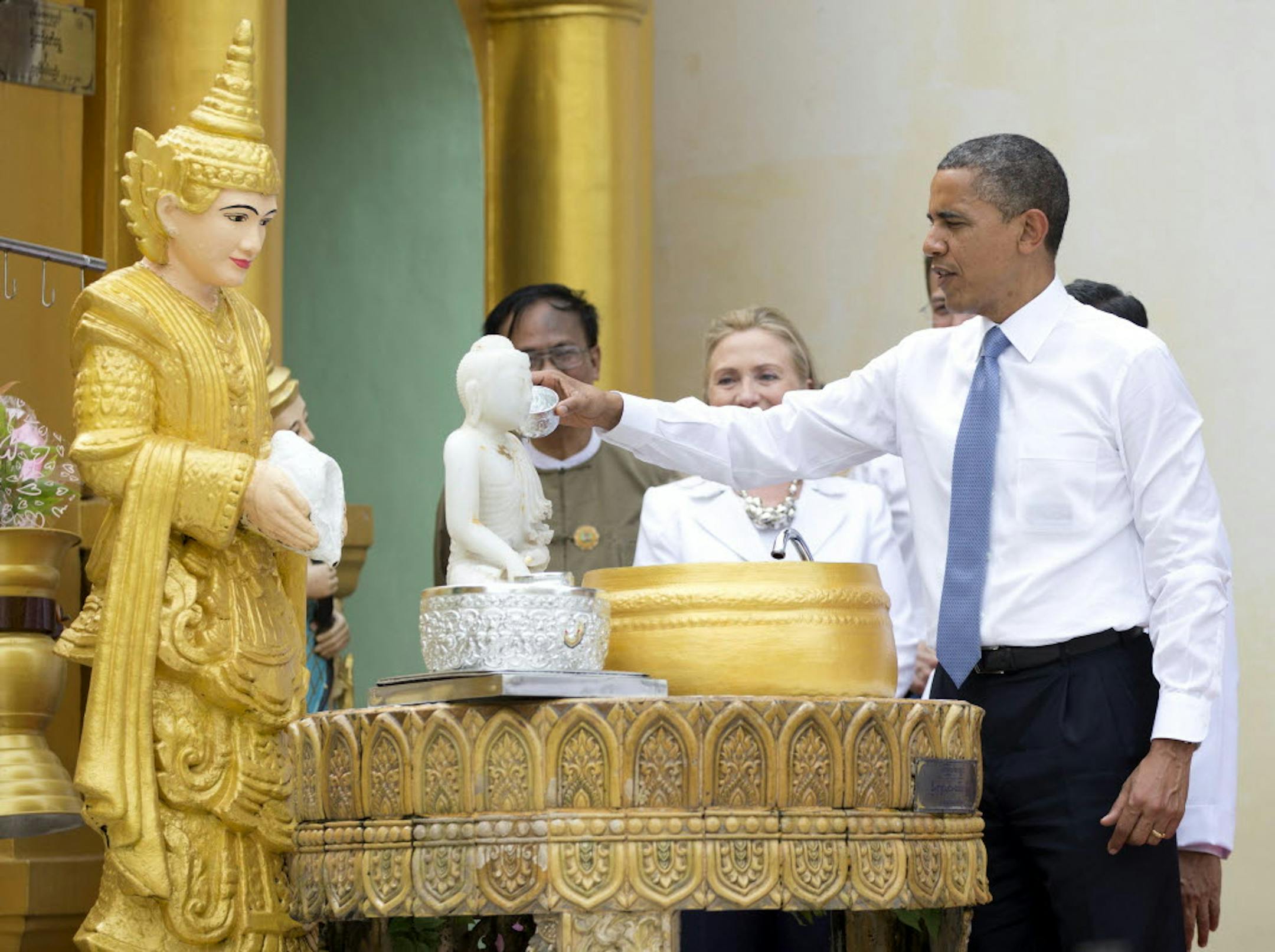 President Barack Obama "douses eleven flames" as he tours the Shwedagon Pagoda with Secretary of State Hillary Rodham Clinton in Yangon, Myanmar, on Nov. 19.