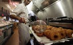 FILE - In this June 3, 2013 file photo, chef Dominique Ansel makes Cronuts, a croissant-donut hybrid, at the Dominique Ansel Bakery in New York. The m
