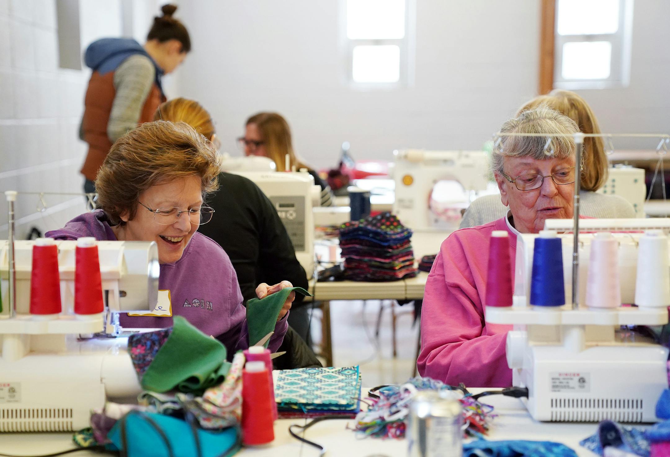 Sara Jane VanAllen, left, and Mary Tholkes, both of Columbia Heights, used serger sewing machines to hem the edges of the feminine hygiene kits. ] ANTHONY SOUFFLE &#x2022; anthony.souffle@startribune.com Minneapolis City of Lakes Rotary Club held a volunteer event to support the Twin Cities chapter of the nonprofit Days for Girls Saturday, Feb. 29, 2020 at the Northeast United Methodist Church in northeast Minneapolis. The "Sew-a-thon" made feminine hygiene kits for girls in developing countries