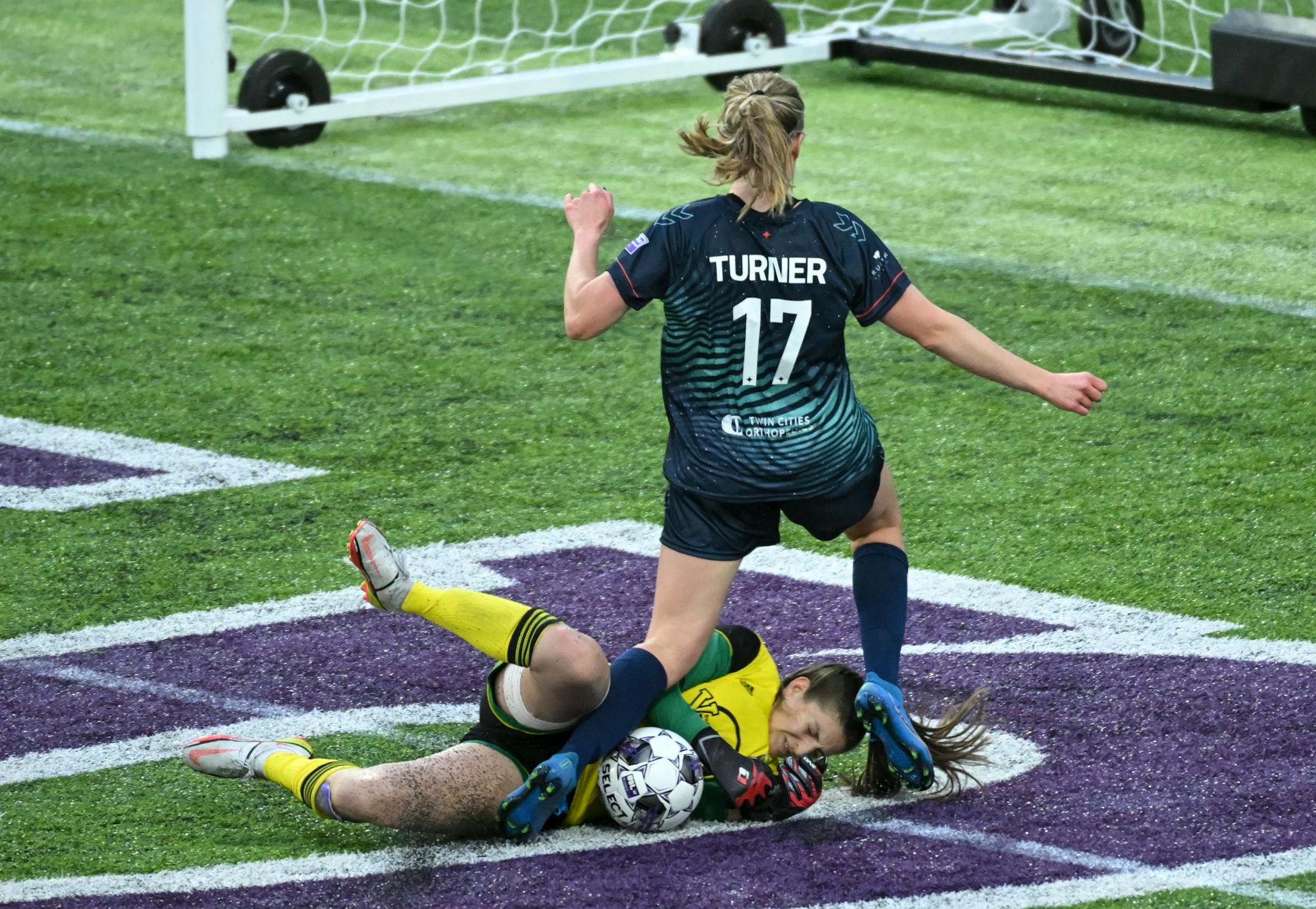 Green Bay goalkeeper Alyssa Stumbaugh makes a save against a scoring attempt by Minnesota's Morgan Turner during the second half.