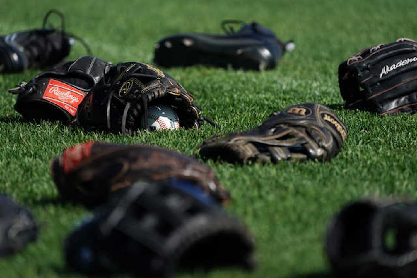 Gloves sat in the grass during a May 4, 2019 practice for the St. Paul Saints at CHS Field.